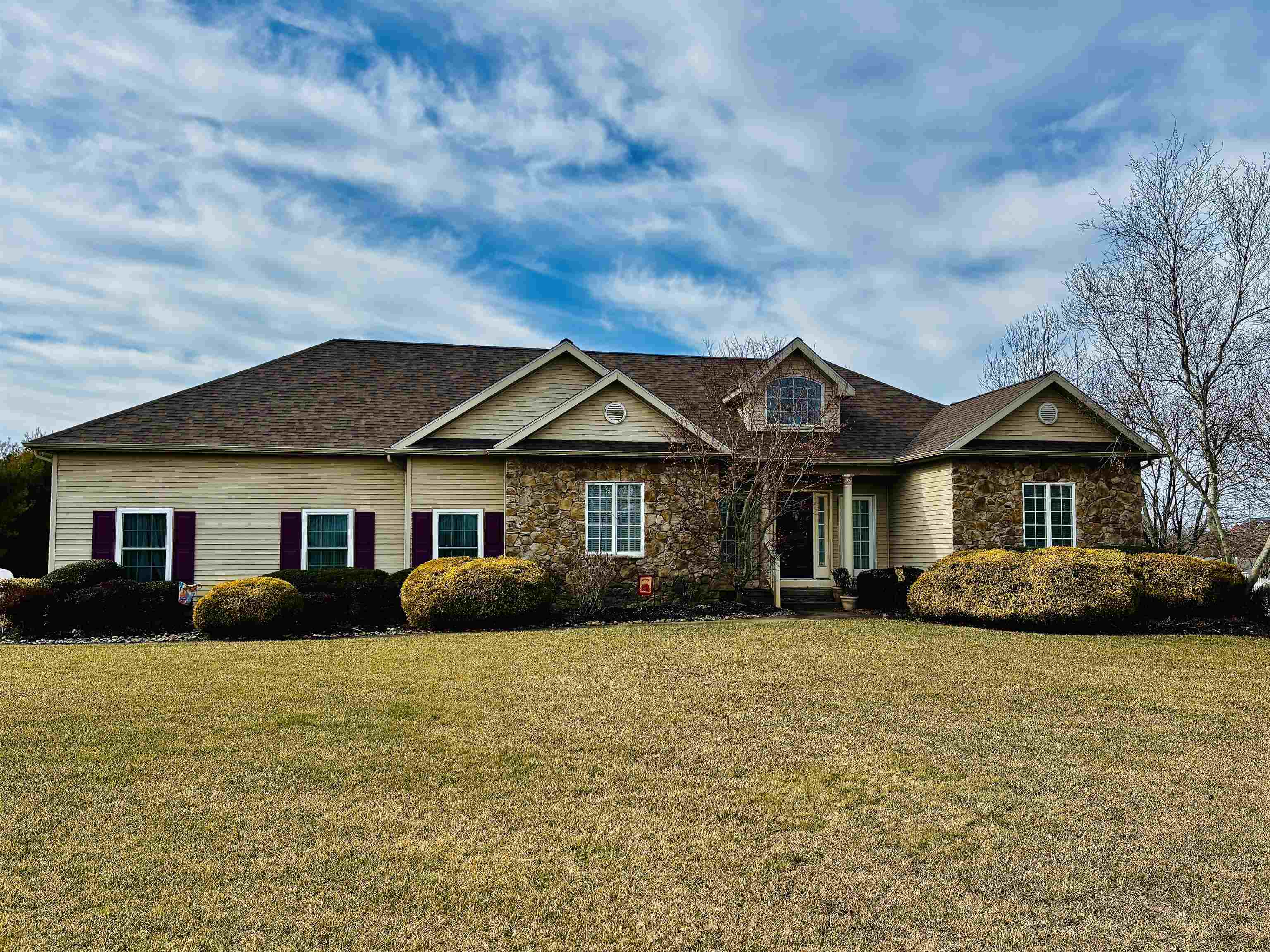 Spacious Rancher with Expansive Lot   Nestled on a generous 45,002-square-foot lot, this stunning 3-bedroom, 2.5-bathroom rancher offers 2,280 square feet of single-level living space, designed for both comfort and style. Perfectly maintained and with your own personal touches move-in ready, this home features hardwood floors and wall to wall carpet throughout the main living areas, enhancing its cozy feel.  The added four season room adjacent to the main living space is perfect for relaxing, reading or enjoying the view and access to the backyard and rear deck.  The open-concept living space boasts soaring cathedral ceilings, creating an airy and inviting atmosphere. The fully appointed kitchen with breakfast nook and bar height peninsula offers plenty of seating for family and friends and flows seamlessly into the dining and living areas, making it an ideal space for entertaining near the double sided fireplace.  The Primary suite is a true retreat, offering tray ceilings for added elegance, a spacious walk-in closet, and a luxurious ensuite with a soaker tub, stand-up shower, dual vanity and double sided fireplace for added ambiance.  Enjoy the ease and convenience of single-floor living, with all three bedrooms and bathrooms located on the main floor.  The full basement with 8-foot ceilings houses all of the home's mechanics, an additional refrigerator and freezer, and offers endless potential for additional living space and/or storage. With a new roof and attached 2-car garage, this home is both functional and stylish. The blacktop driveway adds to the curb appeal, while the expansive lot provides plenty of outdoor space for relaxation or recreation from the rear deck.  Located in a desirable area, this home offers both privacy and convenience. Don’t miss your opportunity to own this exceptional property!  This beautiful property has been meticulously maintained with yearly professional systems checks. New roof Oct. 2024, new Pur water softener 2023, HVAC and tankless hot water 3 years old, and new well 2021.