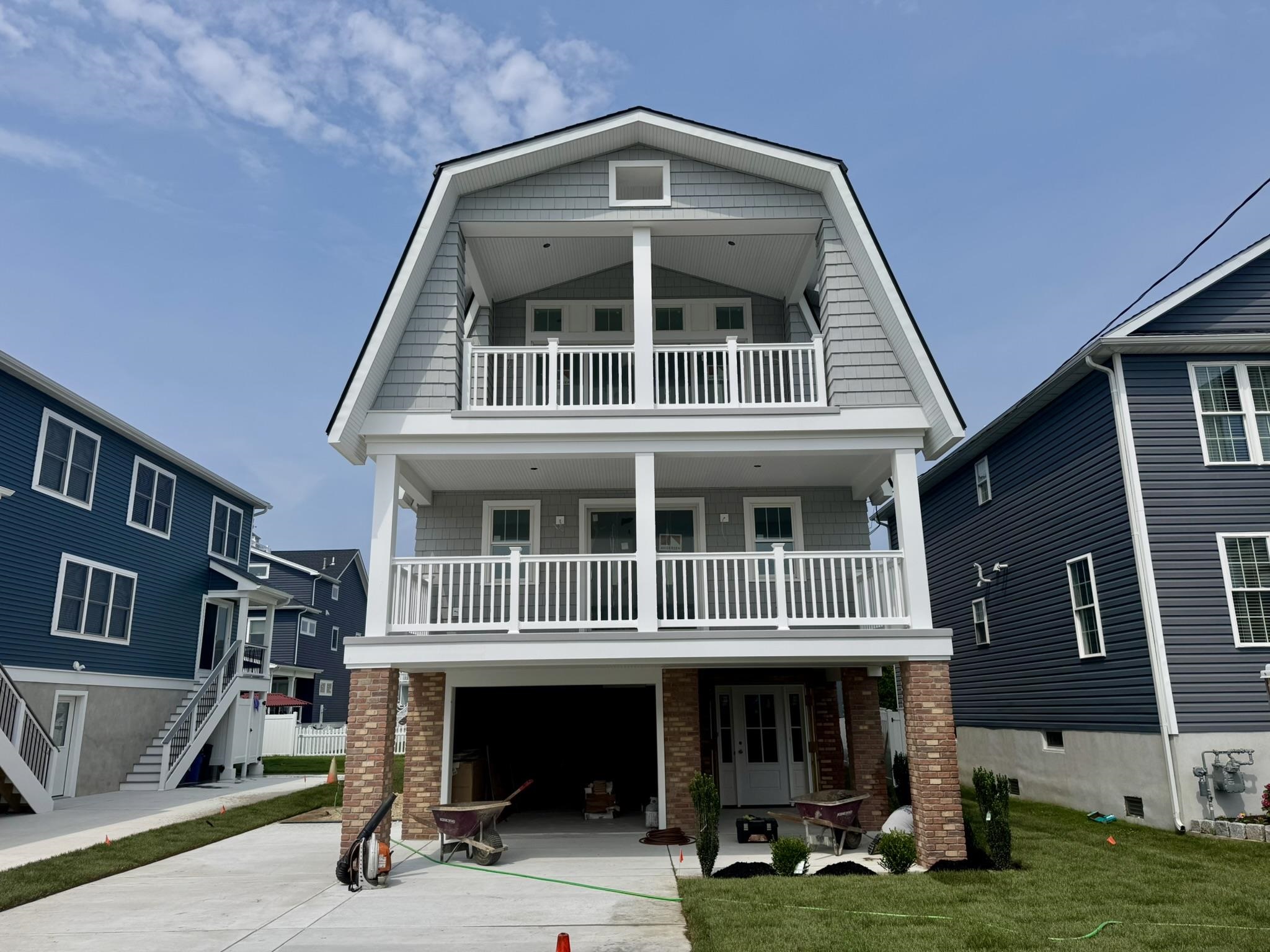 Nestled in the heart of North Wildwood, this brand-new single-family home beautifully blends Nantucket-inspired design with a nod to the rich history of the Jersey Shore. A truly unique creation on 5 Mile Island, this exceptional property is brought to life by Yellow Door Development and the renowned Avalon-based Vallese Contractors. Estimated completion is set for July 2025.   Spanning five bedrooms and 3.5 baths, this home is designed to enhance your coastal lifestyle. Drawing inspiration from the impressive craftsmanship of past developments at 315 E 7th Ave and 405 E 10th Ave, the home sets a new standard for quality construction. With multiple outdoor living spaces, it’s perfect for those who love to entertain and enjoy the beauty of open-air living. The open-concept living and dining areas feature soaring cathedral ceilings and abundant natural light, creating a spacious and harmonious flow.  The chef’s kitchen showcases high-end GE Café appliances, allowing for culinary creativity, while a cozy gas fireplace adds warmth and charm to the living area. The home offers plenty of space with a master suite, a custom-designed bunkroom, and three additional generously sized bedrooms—each thoughtfully crafted to provide the utmost in comfort and style.  High-quality white oak engineered hardwood floors run throughout the home, adding both elegance and durability. With two expansive living areas, you’ll have the flexibility to host gatherings or unwind in peaceful solitude. Step outside to two covered porches offering over 460 square feet of outdoor space, perfect for enjoying the coastal breezes. The custom-designed 12' x 20' gunite pool and outdoor entertaining area on the ground level provide an ideal setting for summer relaxation, whether you’re swimming or sipping cocktails in the sun.  Parking is never a concern with a one-car garage and additional off-street parking for up to four vehicles. Plus, the home features a three-stop elevator for easy access between floors. This exceptional property harmonizes traditional design with modern luxury, offering the ultimate in coastal living.  When it comes to new construction, the builder's reputation speaks volumes. We’re happy to provide references and arrange tours of similar properties to showcase the difference in quality. A full set of plans is available upon request.