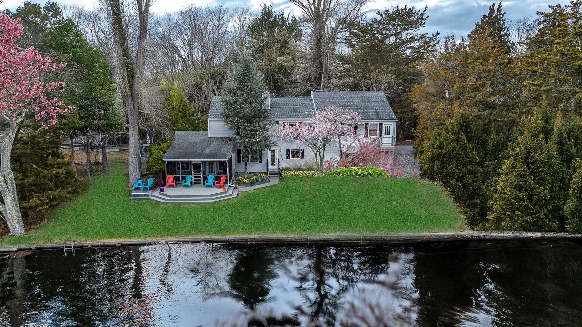 This charming lakefront home offers breathtaking water views and access to the tranquil Ludlam's Pond. This rare property offers a spacious floor plan with over 3,200 square feet of living space, 4 bedrooms, 2.5 bathrooms, a Florida room overlooking the water, second rec/living room, two car garage and much more. This home is being sold as-is.