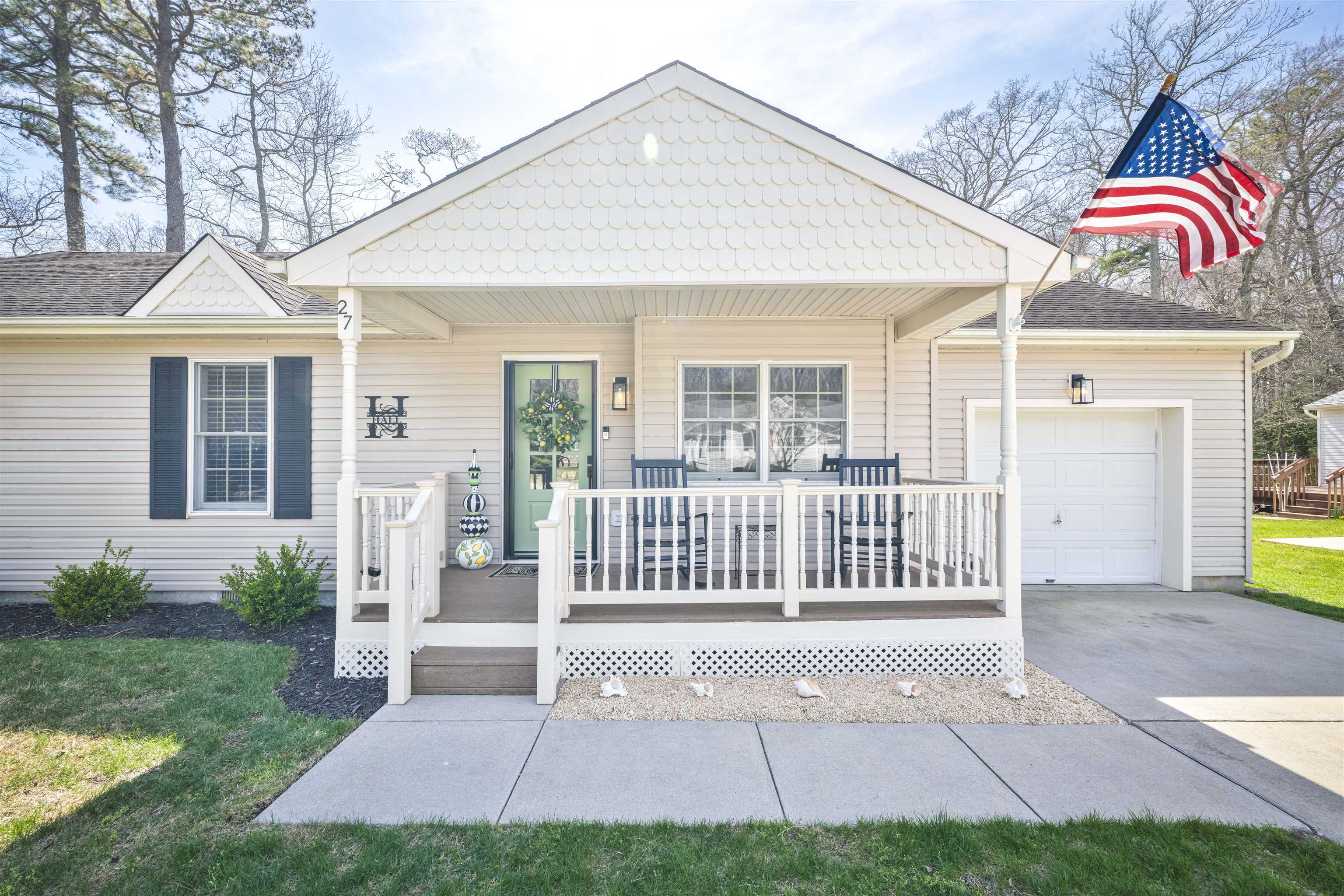 Nestled in the serene Mickel’s Run neighborhood, this charming ranch-style home offers the perfect blend of comfort and convenience, situated just 5 miles from the pristine beaches of Cape May and a mere 3 miles from the tranquil bay. A welcoming front porch, adorned with classic rocking chairs, invites you to relax and enjoy the quiet setting.  Step inside to discover a spacious living room, adorned with new high-end luxury vinyl floors throughout that exude elegance and durability for those sandy feet returning from the beach. A new gas fireplace casts a warm glow, creating a cozy ambiance on cool evenings. The adjacent dining room provides ample space for entertaining, while the updated eat-in kitchen is a perfect place to enjoy your home cooked meals.  The new stainless steel appliance package, gleaming quartz countertops, and a stylish tiled backsplash, make this kitchen a beautiful place to gather with friends. A convenient laundry/utility room off the garage completes the area.  The home features three generously sized bedrooms, each offering a peaceful retreat. The primary suite includes an updated bathroom for added luxury and convenience. A well-appointed hall bath serves the remaining bedrooms.  Outside, the meticulously maintained exterior beckons you to enjoy outdoor living. A spacious back deck with a retractable awning is perfect for al fresco dining or enjoying the quiet wooded area behind the property. Both front and back yards provide ample space for gardening, recreation, or relaxation.  With its idyllic location, modern amenities, and timeless charm, this ranch-style home could be your next dream home for years to come!