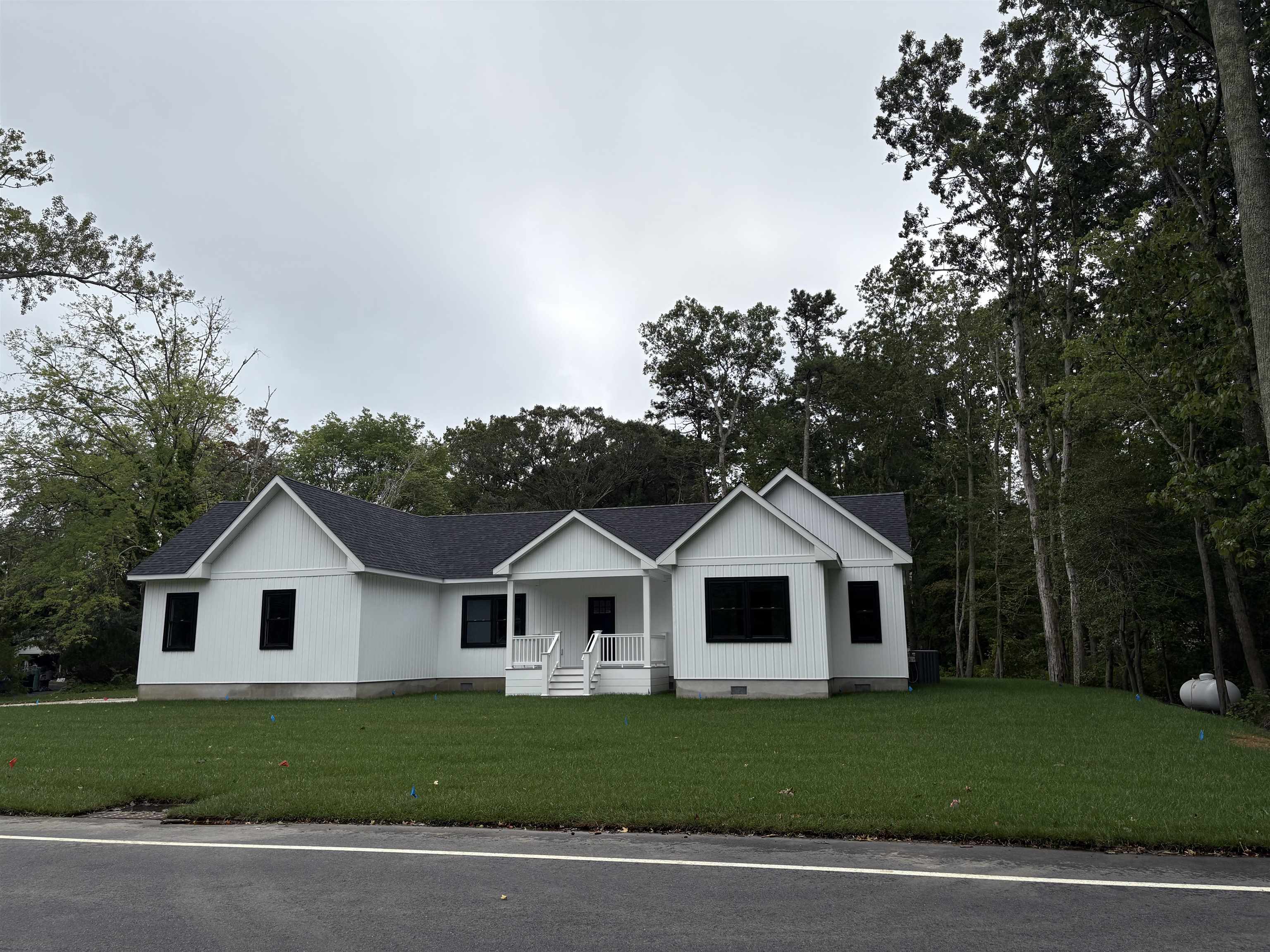 If you are looking for a comfortable home that feels luxurious, and is Carefully planned out, then look no further. The home offers 2500 ft.² of living space on a private 1 acre lot yet is conveniently located within a short driving distance to area beaches, restaurants, shopping, churches, schools, and the hospital. This four bedroom 2 1/2 bath home offers a 23 x 23 attached garage. The main living area has a vaulted ceiling and accent wall. The living spaces have cortex vinyl, Hydro plank, flooring and marble tiled baths. The kitchen features a center island with a granite countertop. There are custom white shaker cabinets, a tiled, backsplash, and stainless-steel appliances. The primary bedroom is privately offset to one side of the house away from the guest bedrooms. The primary suite features a walk-in closet and custom bathroom with a tiled, walk-in shower and double vanity for convenience. The powder room is accessible right off of the garage as well as the laundry room. On the opposite side of the home, you will find all three of the roomie guest bedrooms with generous closet, space and a shared hall bath. If you need an office or den one of the four bedrooms could accommodate. The main room has sliding glass doors from the living space onto a private rear deck. There is plenty of room for a swimming pool, shed, playset... and loads of privacy