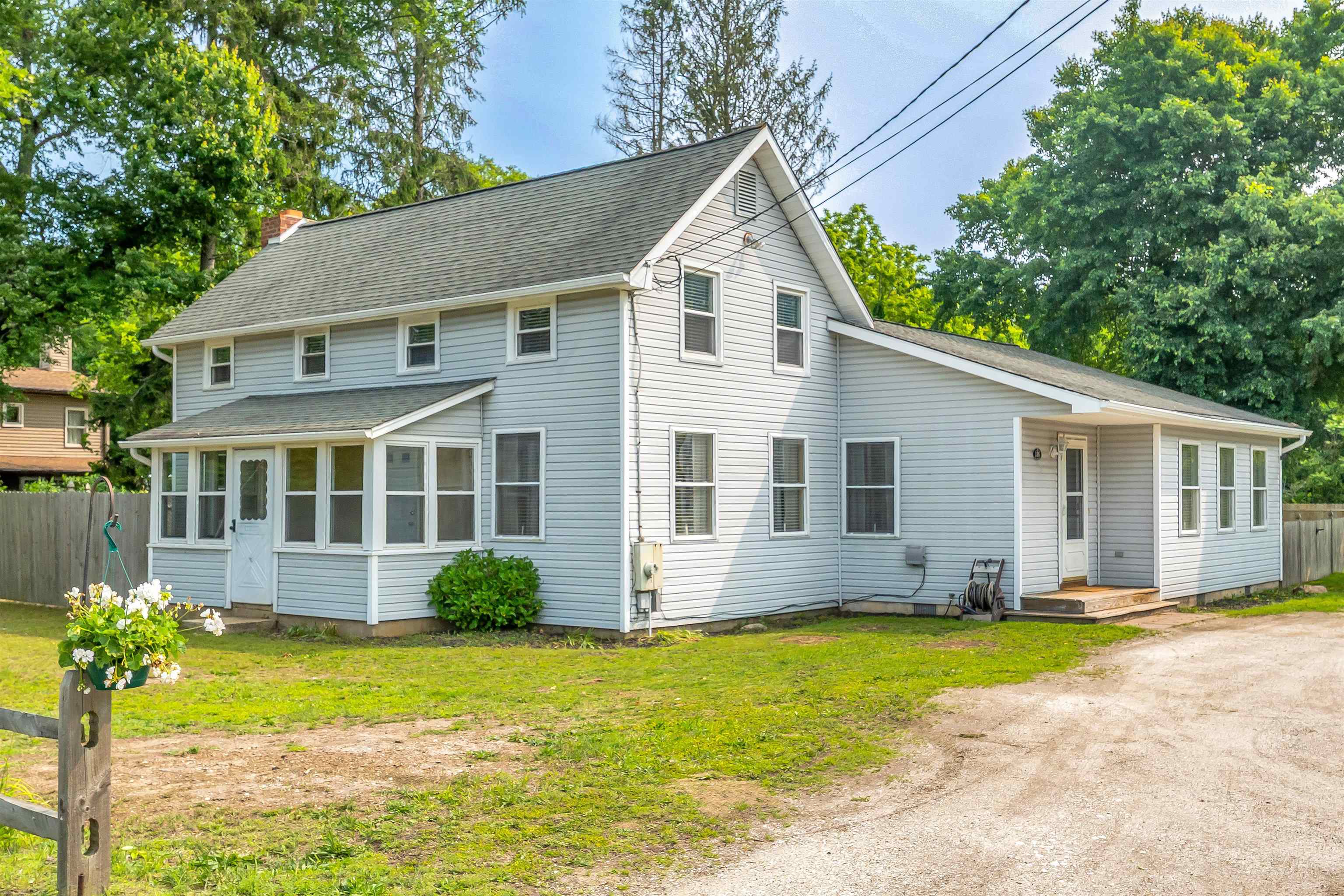 Move in ready Dennis Township 3 bedroom, 3 full bath updated two story house with a first floor master. The master has a full bath and walk-in closet with the other two bedrooms upstairs (15x12 & 9x13). The kitchen has a stainless steel appliance package and granite countertops. The first floor flex/den room has a working wood fireplace that was professionally cleaned in 2023 with hardwood flooring. The 2.6 acre lot is partially cleared with a fenced in backyard and is the perfect space for your horses or farming and has a 27x23 detached garage with a 16x27 workshop that is need of repair. It is located within the desirable Dennis Township school district, in a quiet neighborhood.  Request showings through ShowingTime.