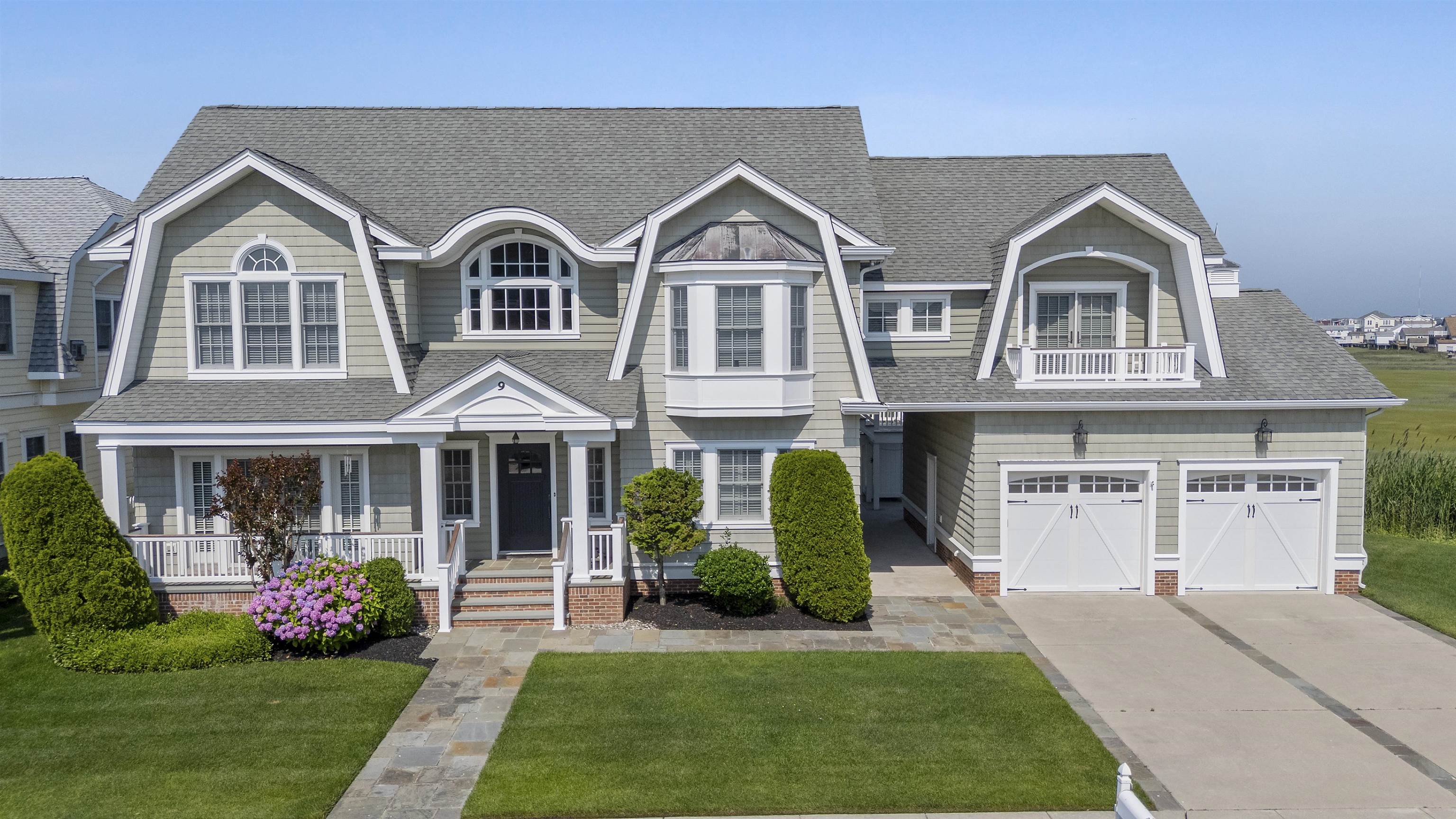 Stunning Blane Steinman–designed retreat on a private, elevated end lot in Avalon Manor with breathtaking wetland/sunset views. Perfectly suited for large families and entertaining friends, every bedroom boasts its own spa-inspired en-suite bath, each offering a unique selection of tiles and finishes. A self-contained first-floor suite features its own kitchenette with dishwasher, cozy living room with fireplace, private deck, and entrance ideal for guests or multi-generational living. Culinary enthusiasts will delight in the gourmet kitchen, equipped with Viking appliances, a dedicated beverage refrigerator, a massive butcher-block island, three dishwashers & three ice makers, along with an oversized butler’s pantry. A built-in dumbwaiter streamlines packages and meal service to the second floor; while soaring ceilings and abundant natural light creates a bright, airy ambiance. Two west-facing decks, each fitted with custom awnings - ensure all-weather outdoor enjoyment, and the two-car garage with expansive loft storage keeps vehicles and gear neatly out of sight. This meticulously crafted Shore sanctuary elegantly combines everyday convenience with luxury living. The property is sold unfurnished and closing not before 11/15 or upon delivery of the seller’s new home which is under construction.   Seller prefers showings between 10:00am – 1:00pm.