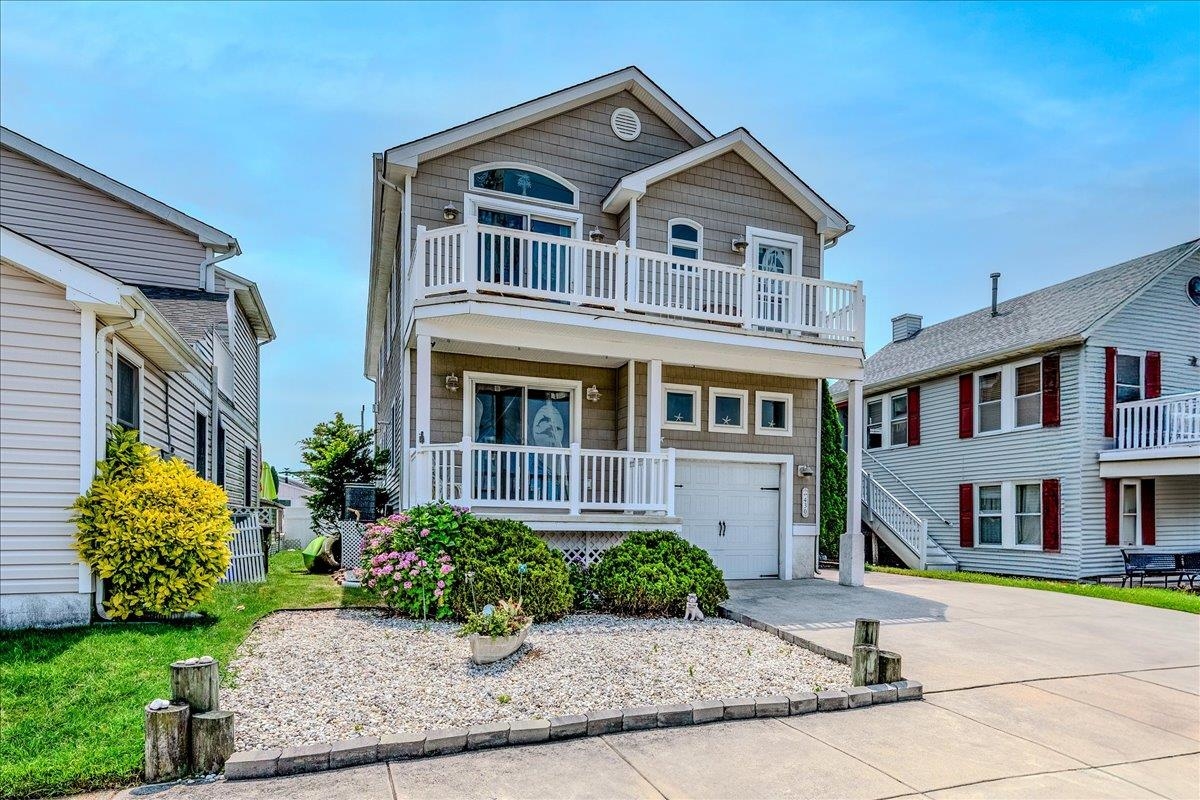 Down the shore everything’s all right, and it truly is at this beautifully upgraded upside-down style home, tucked away on a quiet one-way street in the peaceful bayside section of Wildwood. Whether you're looking for a second home, a forever spot, or just a place to soak in the sun and sea breeze, this is the one that’ll steal your heart.  The bright, wide-open layout is made for shore living, with dramatic vaulted ceilings and a spacious great room that opens through double sliding glass doors to an oversized rear deck, perfect for coffee at sunrise or wine under the stars. “I got no time for the corner boys, down in the street makin’ all that noise”, just peace, quiet, and the soft hum of the bay.  Each of the four spacious (and themed) bedrooms offers direct access to an outdoor deck, where you can feel the sunshine and let the breeze roll in. The upstairs master suite is your private escape, complete with dual walk-in closets, a beautifully tiled ensuite bath, and its own deck out front, ideal for slow mornings and salty air.  Upgrades throughout the home include newer Andersen Renewal windows and sliding doors on the upper level, rich hardwood floors in the foyer and kitchen, custom paint and window treatments, a cozy gas fireplace, recessed lighting, and a stunning kitchen with granite countertops, beachy backsplash, and custom cabinetry with crown molding.  Parking? We have it! 3 driveway spots plus space in the garage, and if you need more it's an easy block to park on. Dual-zone Nest-enabled central A/C and gas heat keep the home comfortable year-round. Newer Samsung washer and dryer add convenience, and outside, the fully fenced backyard features your very own private swim spa, perfect for pampering yourself or entertaining friends. So take that ride across the river to the Jersey side, you don’t have to go far. You’re already here.  The first level offers three large bedrooms and a beautifully tiled full bath, while the upper level is reserved for the master retreat. With four total outdoor decks and every thoughtful upgrade already in place, all that’s left to do is move in and enjoy.  Down the shore everything is alright, so schedule your showing today.