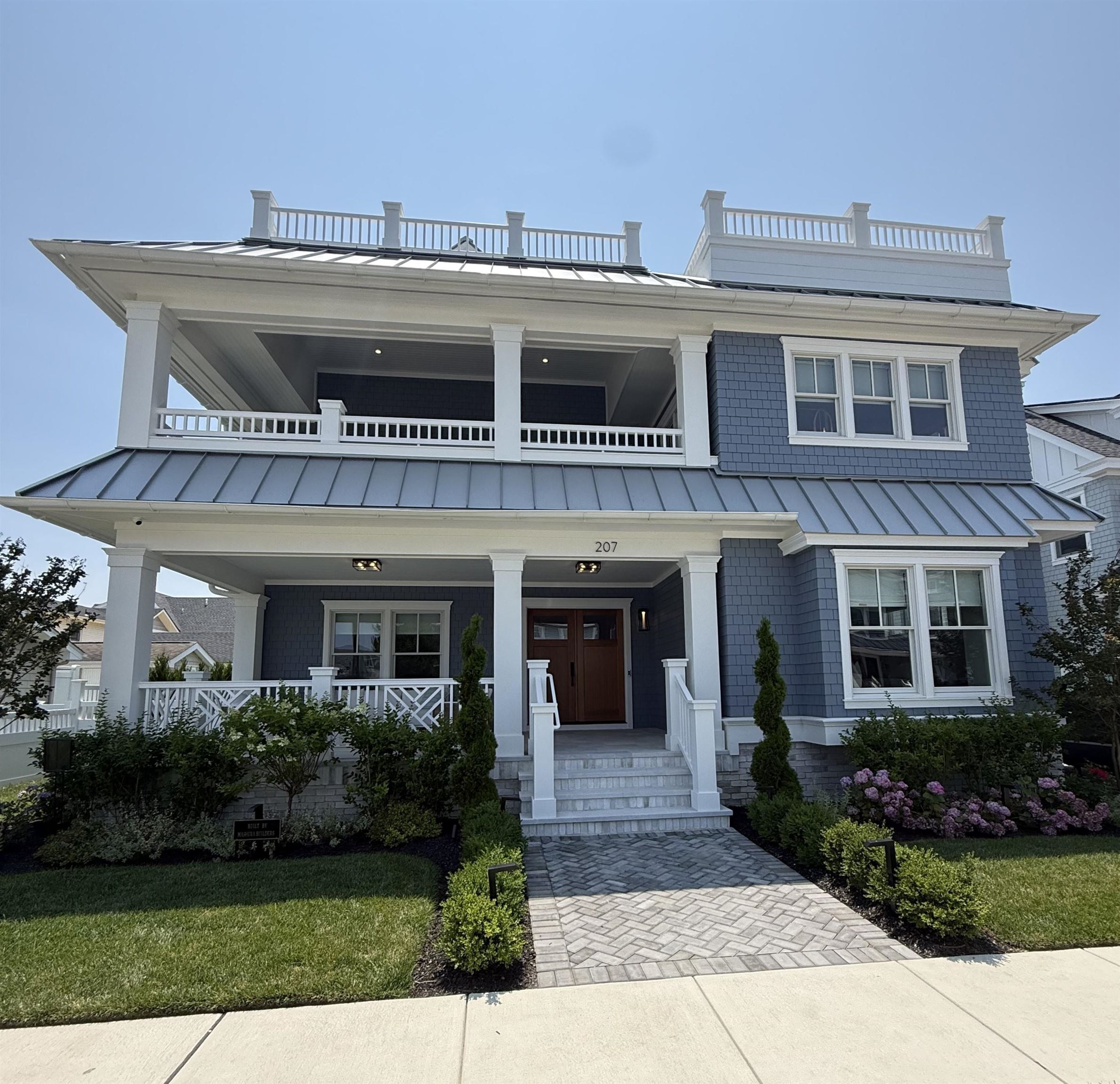 Presenting 207 120th Street — a newly constructed, 6-bedroom, 5.2-bathroom, luxury estate located just a short block from the beautiful beaches in the exclusive south end of Stone Harbor. This one-of-a-kind residence, fully furnished, coastal luxe designed home by Mashura Builders, blends elevated craftsmanship with modern coastal elegance.  This home offers a warm, welcoming covered front porch leading to a spacious first level entry foyer.  Here you will find a splendid staircase and an elevator providing convenience to move through the home's generous floor plan. This level boasts 4 bedrooms, two having ensuite baths, and a two-bedroom suite area with a full bath well designed to accommodate a visiting family. This level also includes a laundry room, and a large entertainment retreat with a half bath that opens out to an expansive private oasis to enjoy the ultimate shore lifestyle. This is where you will enjoy relaxing on the suspended daybeds in the shade of the veranda or lounge on the expansive sun-drenched patio by the magnificent saltwater pool and attached hot tub, all finished with stunning shades of white marble surrounded by exquisite landscape. The oversize cabana with a bar and A/v system offers a fun place to gather friends to enjoy your favorite beverages and sporting events.     The second level great room showcases a comfortable living area with soaring ceilings, custom fireplace, and a generously sized attached covered deck to accommodate outdoor dining and relaxation. The gourmet kitchen is embellished by fine custom cabinetry, Sub-Zero appliances, oversized breakfast bar, striking natural quartzite countertops and elegant porcelain tile wall finishes. The spacious dining area allows plenty of room to share memorable times and meals together with family & friends. There is also a common half bath and two bedrooms with ensuite baths and balconies overlooking the lovely rear yard recreation area. The stunning primary bedroom suite embraces a spa-like bath, walk-in closet, and custom architectural finishes.  The third level sky deck is the pinnacle of enjoyable bonus space as it is conveniently accessible by both the interior staircase and by elevator. The sizable 450 SF open deck area with amazing ocean and sunset views offers an endless delight of bright sunny days and cool breezy nights under the stars. Outfitted with expansive teak sectional seating, high top table and a built-in gas grille make this an ideal place to socialize or for a peaceful escape.    Offered fully furnished with coastal-inspired hand-selected pieces, Hunter Douglass motorized window shades, Wi-Fi security cameras, A/V systems and much more as expected with a high caliber home. This property is move-in ready—ideal as a primary residence, vacation getaway, or luxury investment property.