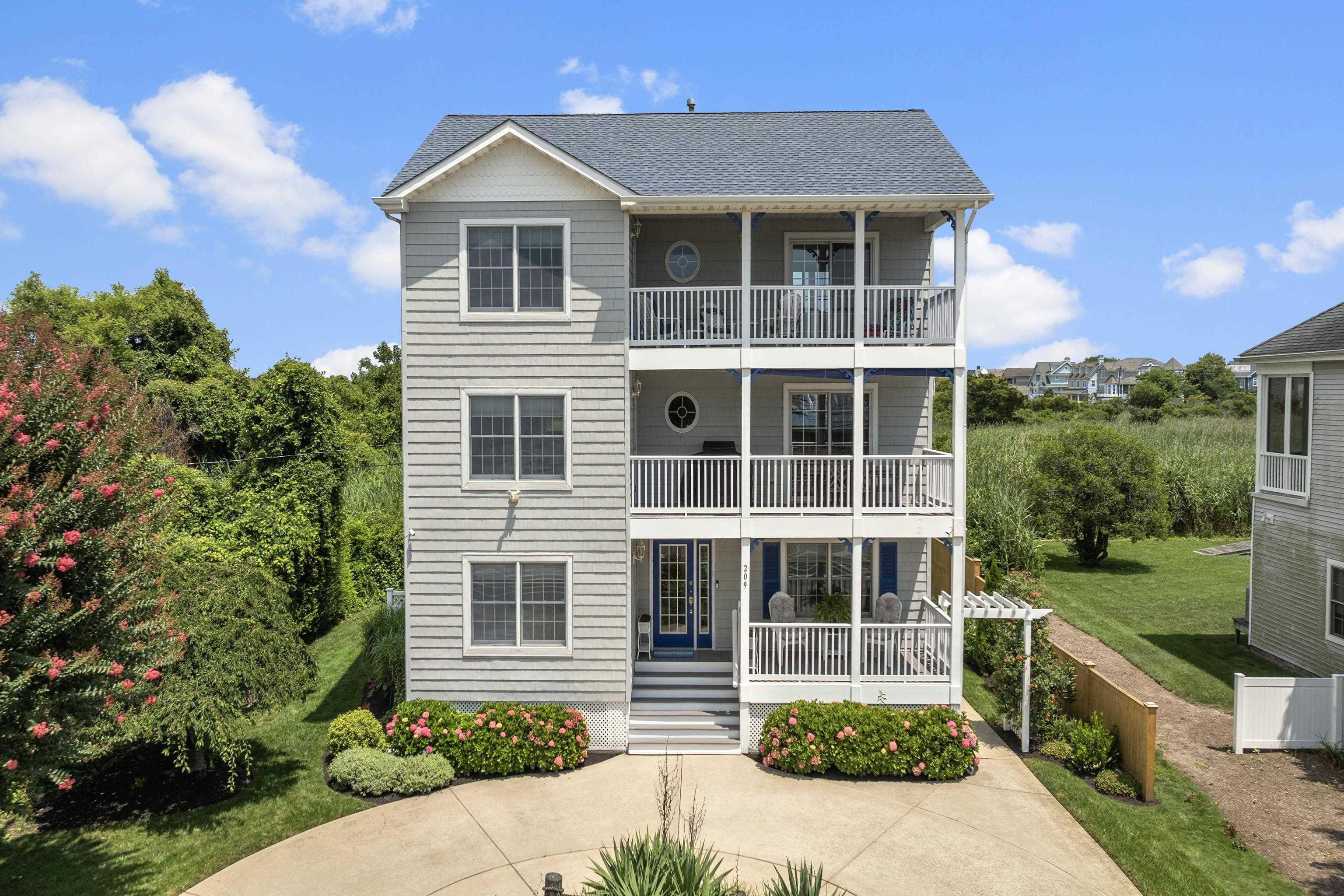 Welcome to 209 Pittsburgh Avenue, located in the esteemed eastern part of Cape May. This exceptional property is a mere two blocks from Cape May’s renowned beaches and boasts the unique advantage of no rear neighbors. This three-story residence offers a total of four bedrooms, two-and-a-half bathrooms, and a total of four covered porches. Situated on a generously sized 60’ x 125’ lot, the home encompasses approximately 2,604 square feet of meticulously designed living space.  Upon arrival, a thoughtfully designed, wide U-shaped driveway provides efficient off-street parking for multiple vehicles. Entering the home via the main entrance on the first-level porch, you are greeted by an inviting foyer. This level features three spacious bedrooms, a full bathroom, a dedicated laundry room with a utility closet, and a convenient rear entryway with additional storage beneath the staircase.  Ascending to the second level, you'll discover the main living space, showcasing an open floor plan that seamlessly connects the living room, a large dining room, and kitchen. The living room is enhanced by a gas fireplace, a storage closet, and a sliding glass door leading to a covered porch. A conveniently located half bathroom is situated between the living and dining areas. The fully equipped kitchen is efficiently designed, ready to inspire any culinary enthusiast in crafting elegant meals.  The third level of 209 Pittsburgh Avenue is dedicated entirely to the private primary suite.  The third floor opens to a second spacious living room that gives access to both a front deck and back deck overlooking the scenic open space.  This expansive retreat includes a large master bedroom, a full bathroom and a generous walk-in closet.  Outside, the property features a built-in, covered outdoor shower in the backyard, large enough to include storage of gardening and beach accessories. Alongside this, you'll find an open grass area in both the rear and side yards.  This versatile outdoor space presents a blank canvas, offering the opportunity to personalize the landscaping to your exact vision. Built on pilings, 209 Pittsburgh Avenue also features a hurricane rated roof.  This property has been meticulously cared for by the same owners since its construction and has never been used as a rental property. The sale includes the furniture, with the exception of a few select items and personal belongings. Its well-conceived interior floor plan, multiple porches, and close proximity to the beach make it an ideal location for both personal enjoyment and as a sound investment.