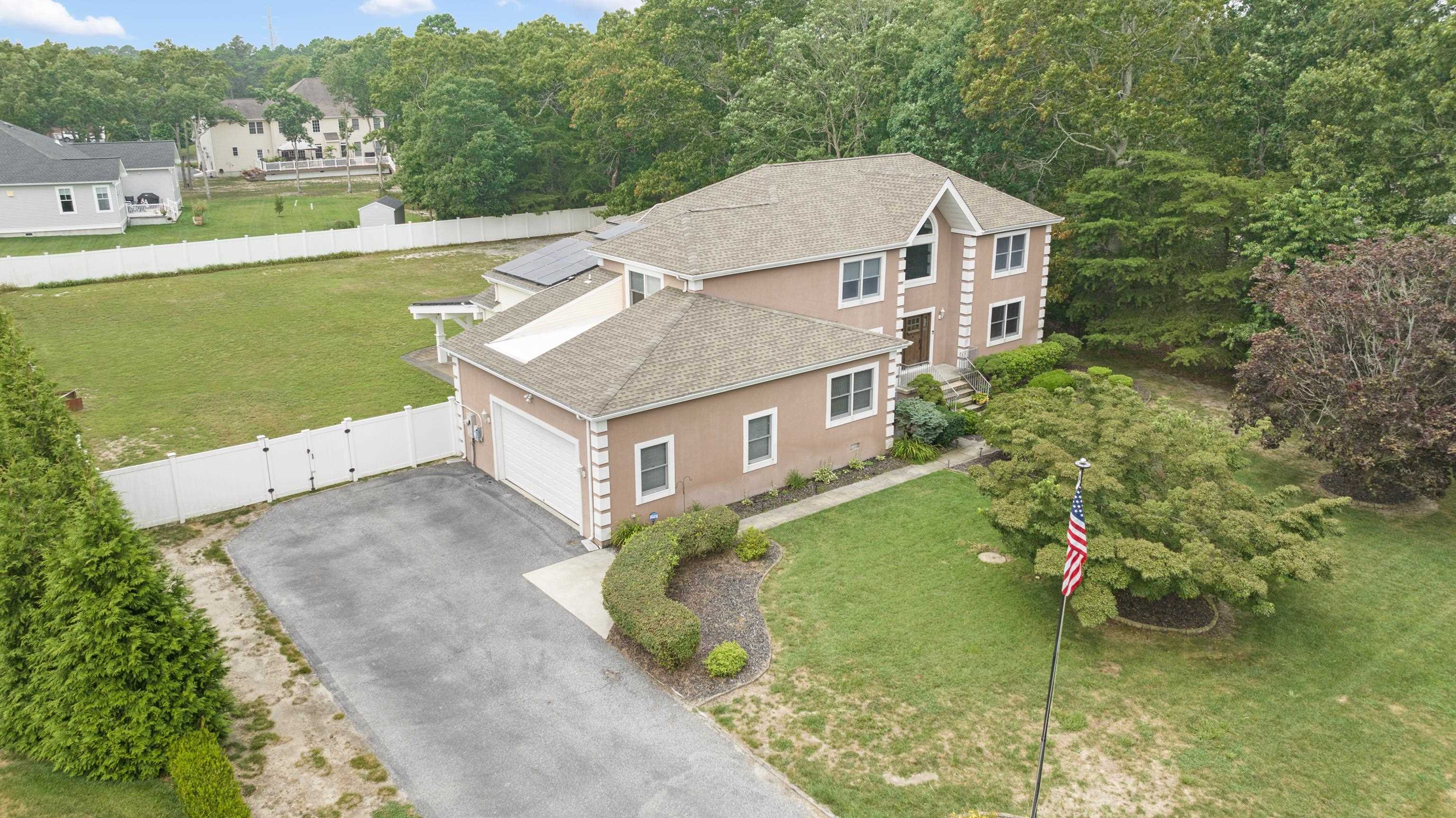 Experience refined coastal living in this exceptional Seaville residence, perfectly set on just under an acre in one of Upper Township’s most desirable locations with a top rated Upper Township school district. Offering over approximately 3,200 sqft of beautifully designed living space—plus a 1,200 sqft basement and a 2.5-car heated garage with oversized insulated doors and a full storage loft—this home delivers a rare combination of elegance, comfort, and functionality. A grand foyer welcomes you into a sophisticated main level featuring a formal living room with a gas fireplace, an elegant dining room with a built-in wet bar, and a chef’s kitchen appointed with granite countertops, Viking gas cooktop, double electric self cleaning wall ovens, two dishwashers, and a walk-in pantry. The spacious family room offers a relaxed gathering space, while the generous first-floor home office provides an inspiring environment for remote work or creative pursuits complete with a separate exterior entrance. An additional mudroom, powder room, and thoughtful flow between spaces make this home ideal for both everyday living and entertaining. Upstairs, the luxurious primary suite is a private retreat with its own gas fireplace, spa-like bath featuring a walk-in shower with multiple heads, a separate whirlpool tub, and a double vanity. Three additional bedrooms, a versatile bonus room, a full bath with double vanity, and a laundry room ensure ample comfort for family and guests. Modern amenities abound, including, hardwired Cat 5 internet throughout, two-zone HVAC, programmable thermostats, tankless water heater, owned solar panels with transferable SRECs, a security system, a 6-zone irrigation system, and interior emergency lighting, and gray water system.  Outside, opportunity awaits to create the custom backyard of your dreams! The oversized fenced backyard is a serene escape with a paver patio and arbor, equipped for a movie projector hookup, open patio for sun-filled afternoons, outdoor shower, shed, and Bilco doors to the basement. Built in 1997 and cared for by the original owners, this meticulously maintained property offers luxurious living, abundant space, and a peaceful setting—just minutes from Ocean City and Sea Isle City beaches. Video Tour link in listing