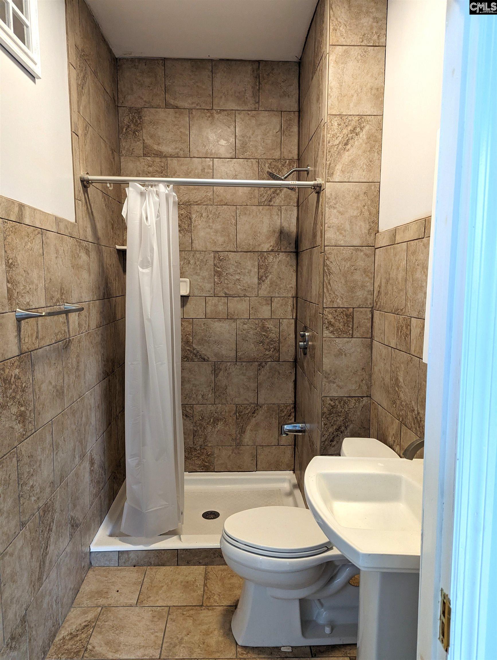 This shower is off the sitting area in the kitchen. Great for coming in from the pool.