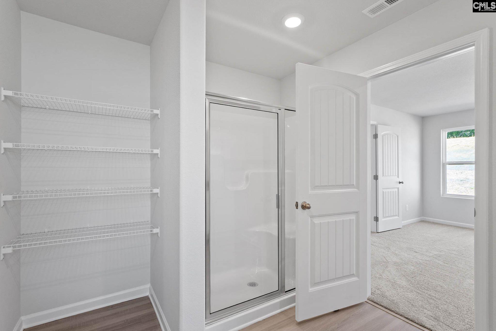 The second bathroom features a spacious vanity and tub/shower.