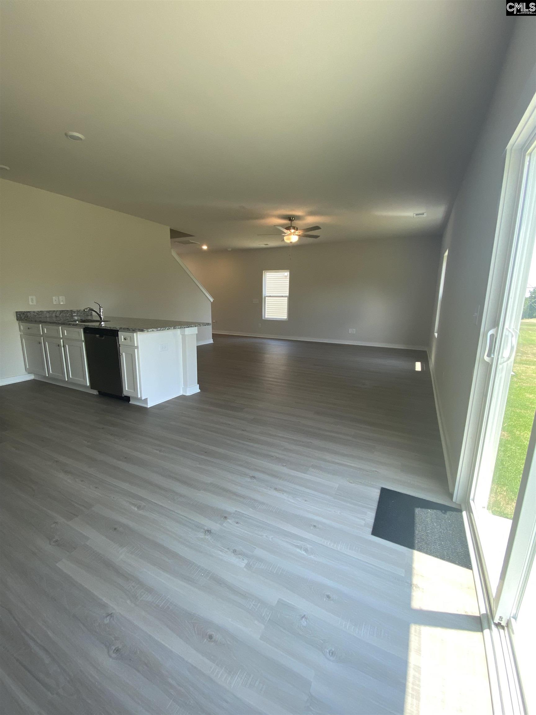 Located off the kitchen, the dining nook showcases luxury vinyl plank flooring and a large window.