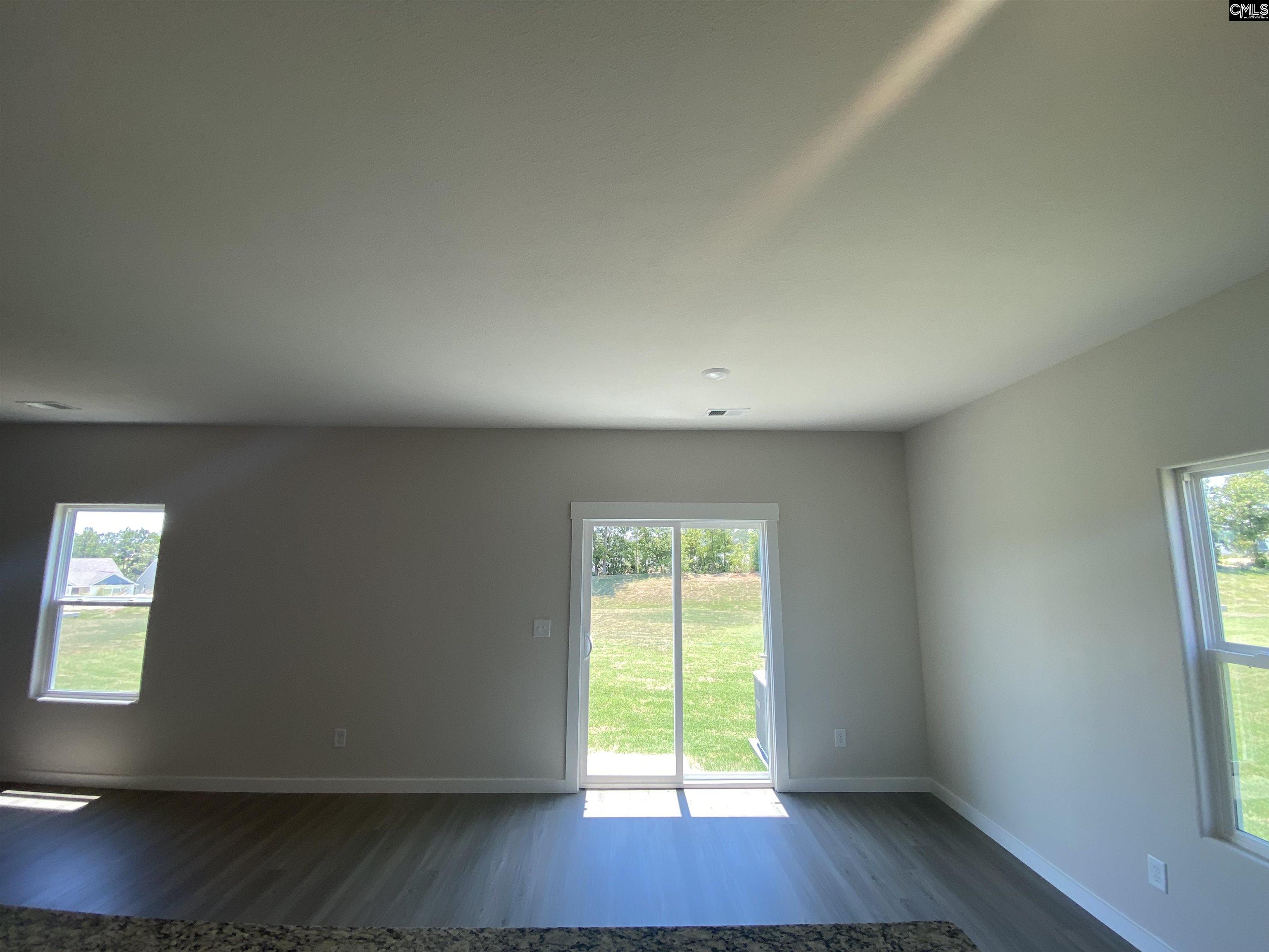 Located off the kitchen, the dining nook showcases luxury vinyl plank flooring and a large window.