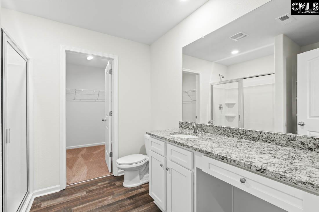 A walk-in shower and a large vanity are showcased in the master bath.