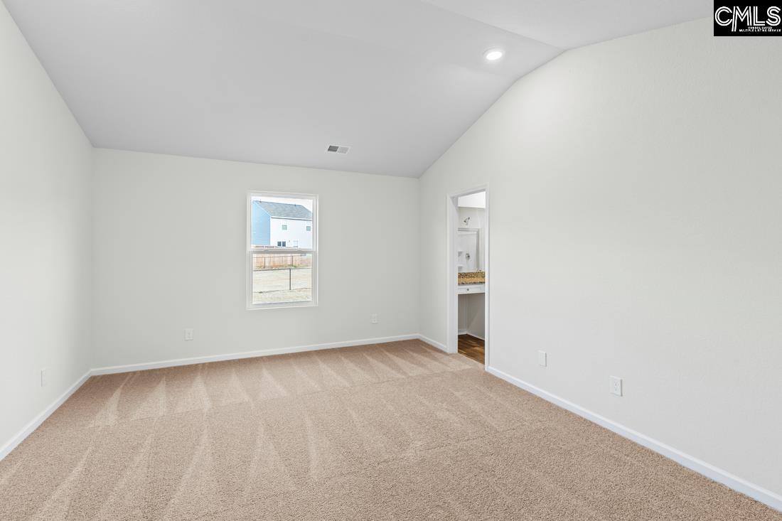 The master bedroom is spacious with a vaulted ceiling plenty of natural sunlight.