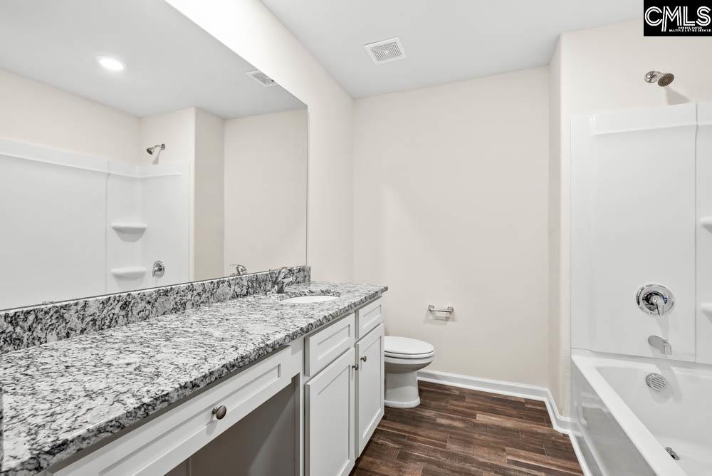 The second bathroom features a spacious vanity and tub/shower.