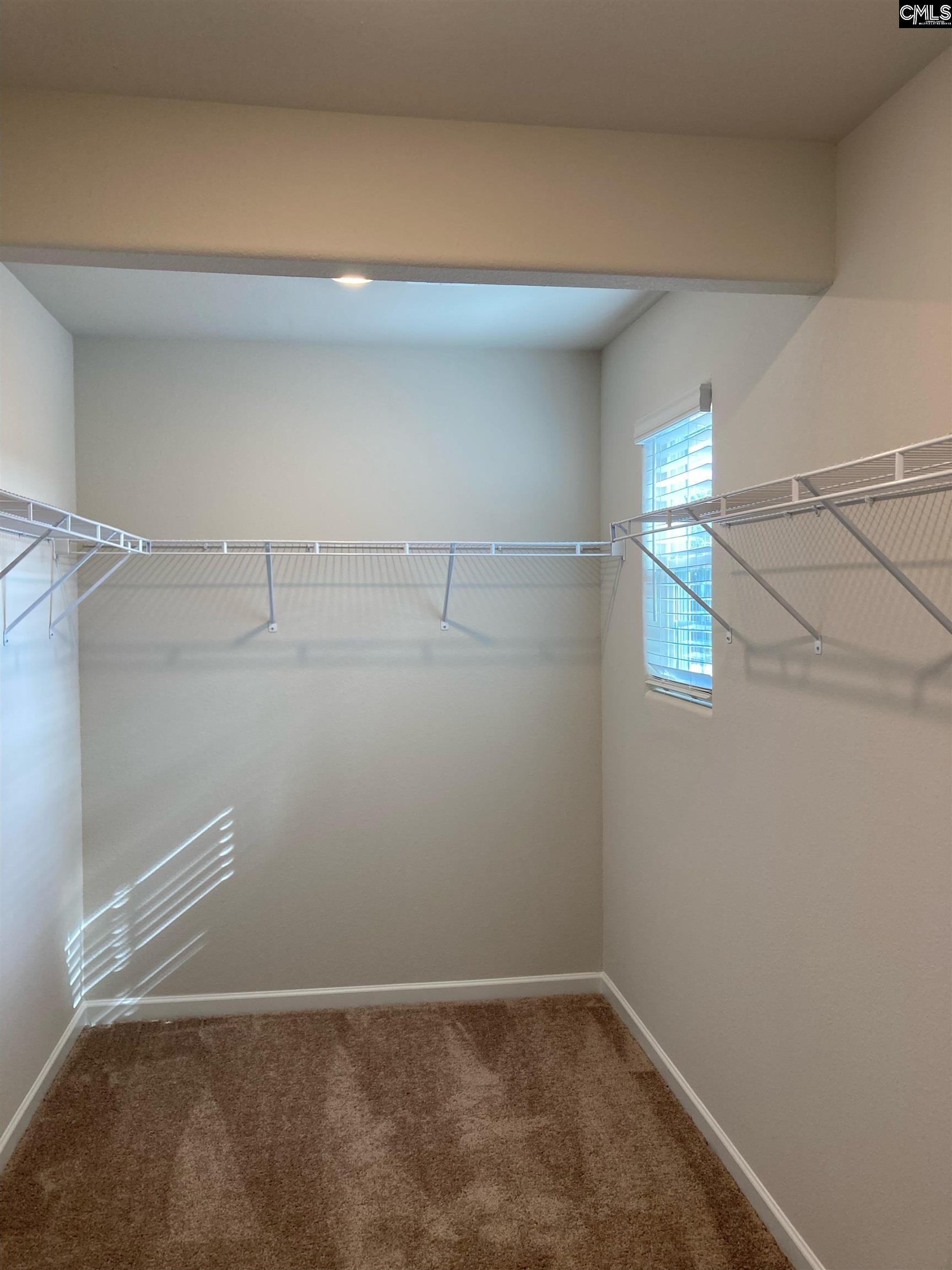 Spacious walk-in closet with tons of storage.