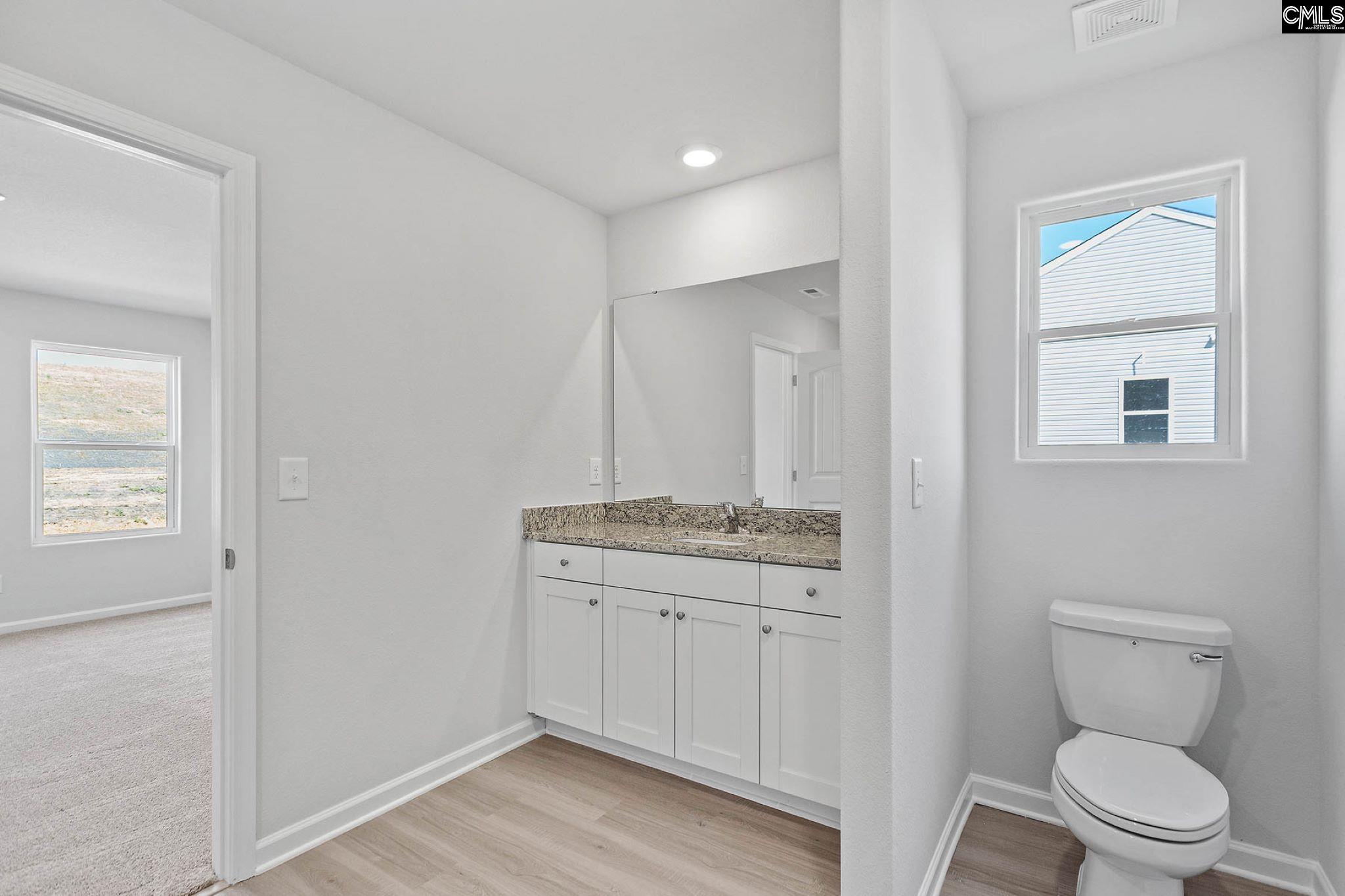 A walk-in shower and a large vanity are showcased in the master bath.