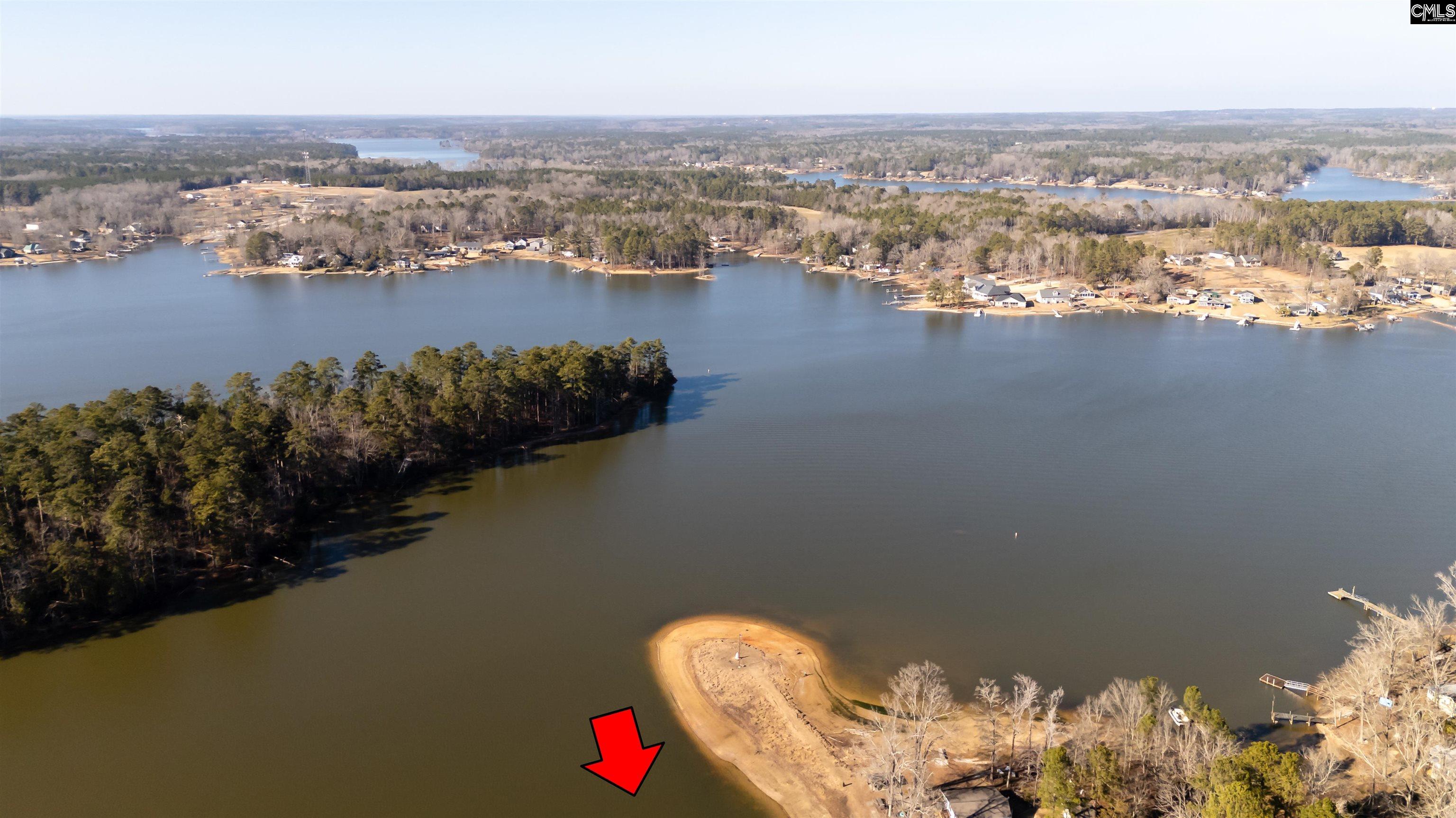 The sand bar will be covered by water. The undeveloped peninsula is owned by the utility company
