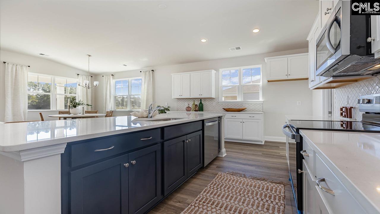 *Navy is pictured, but this home\'s kitchen island will be DUNE.