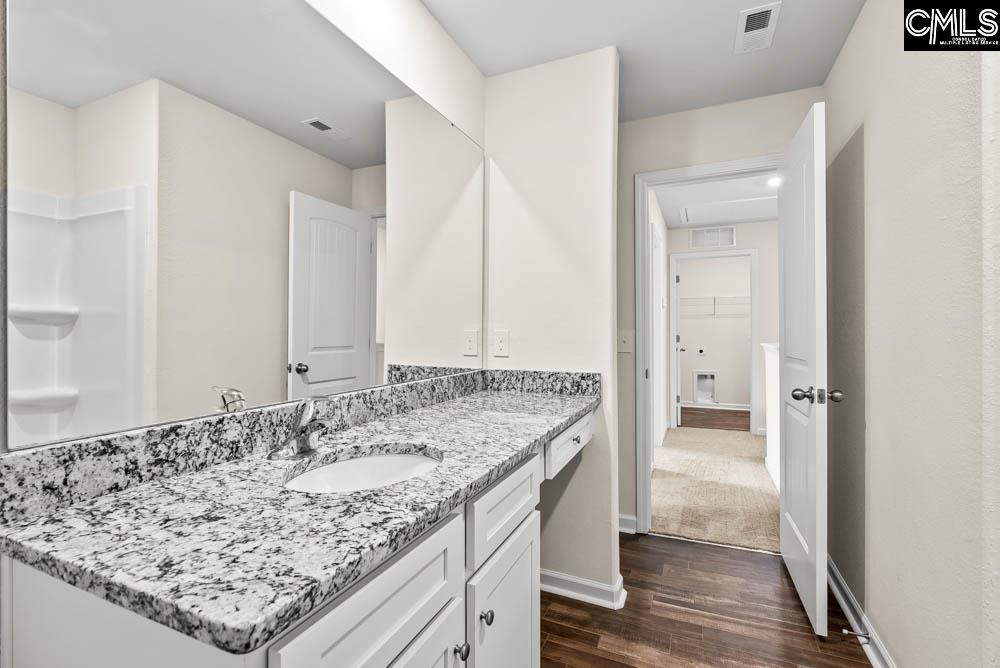 The second bathroom features a spacious vanity and tub/shower.