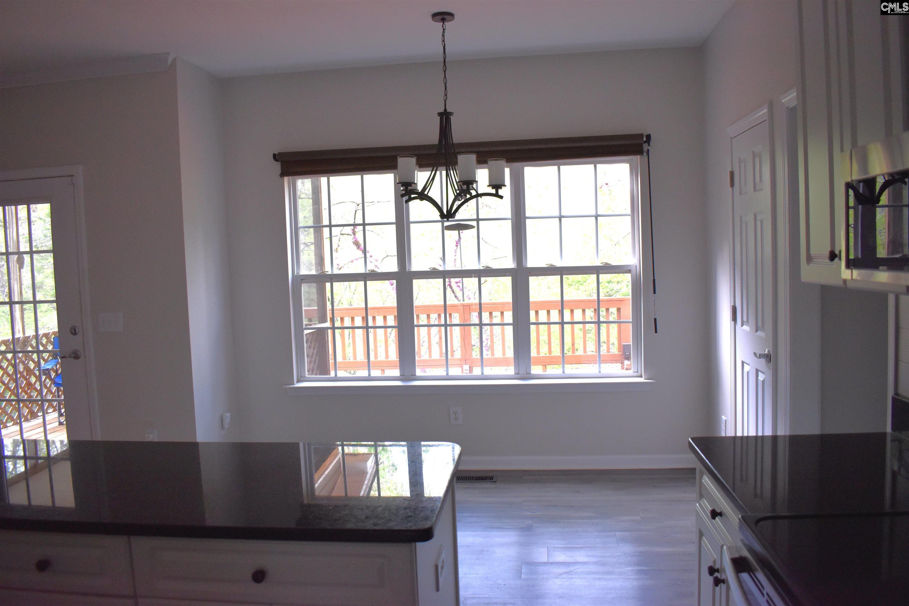View from the kitchen and breakfast nook to the back yard
