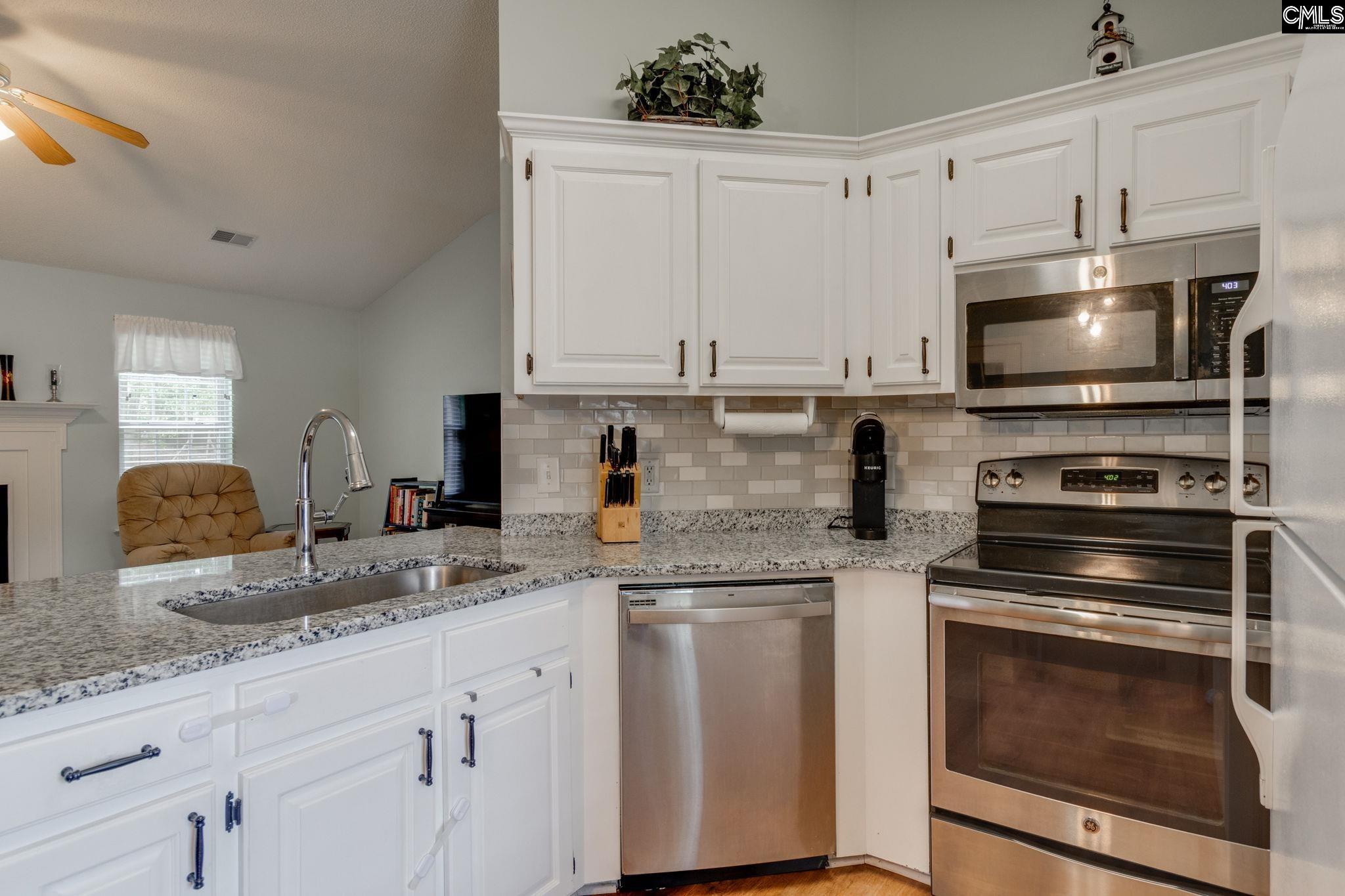 Updated granite countertops and tile backsplash