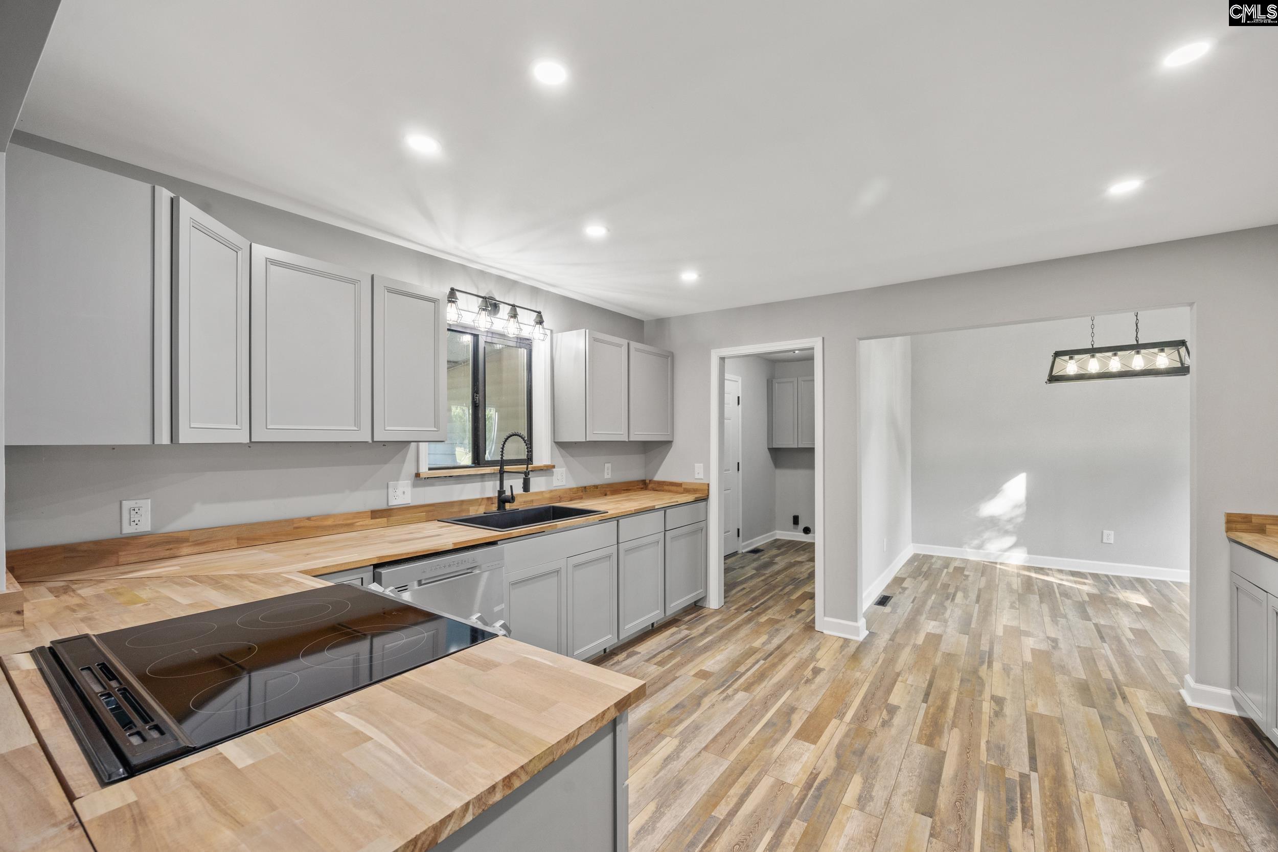 Looking into the Dining Room on the Right and the Laundry Room on the Left exiting into the Garage.