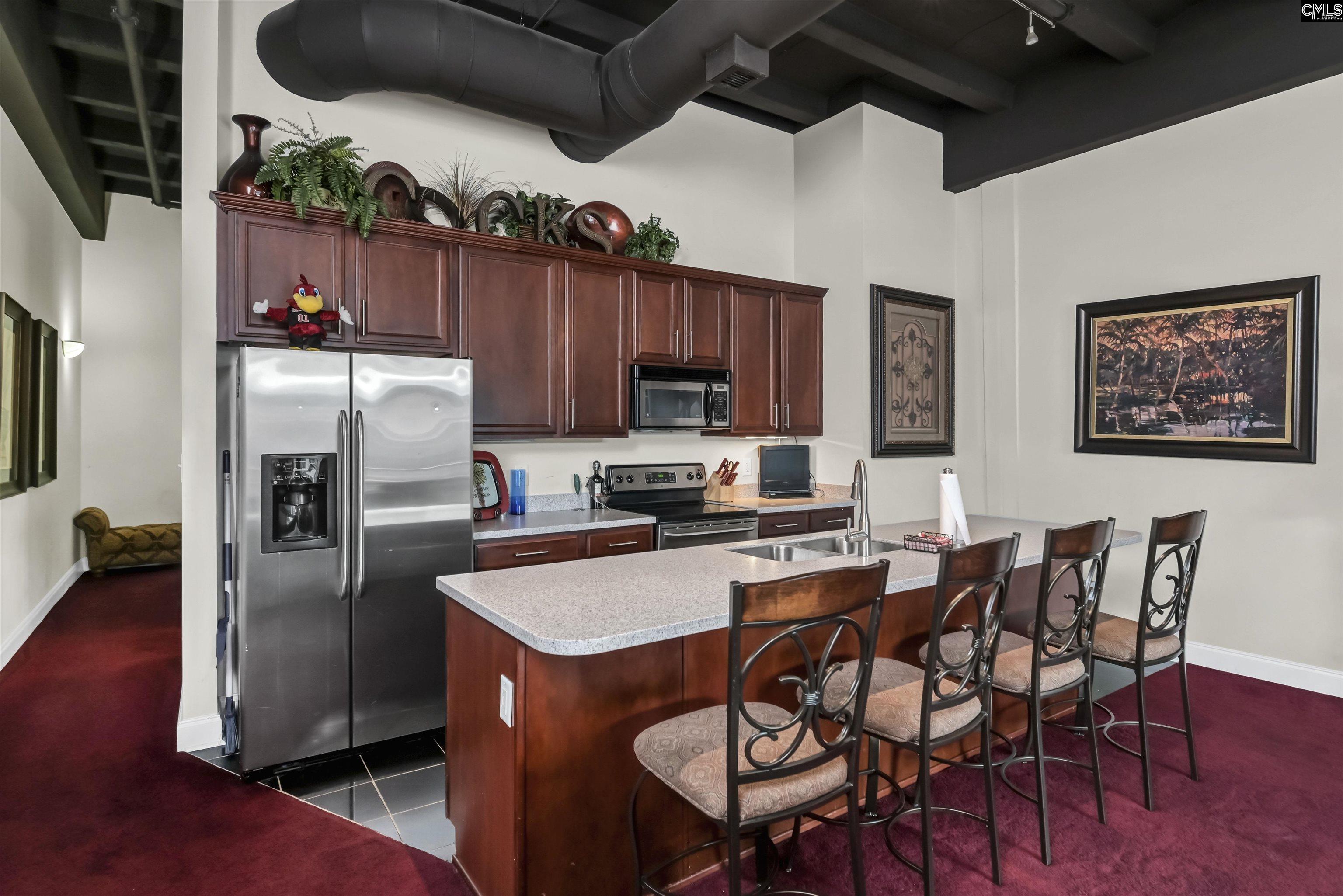Kitchen features tile floor with furnish bar area