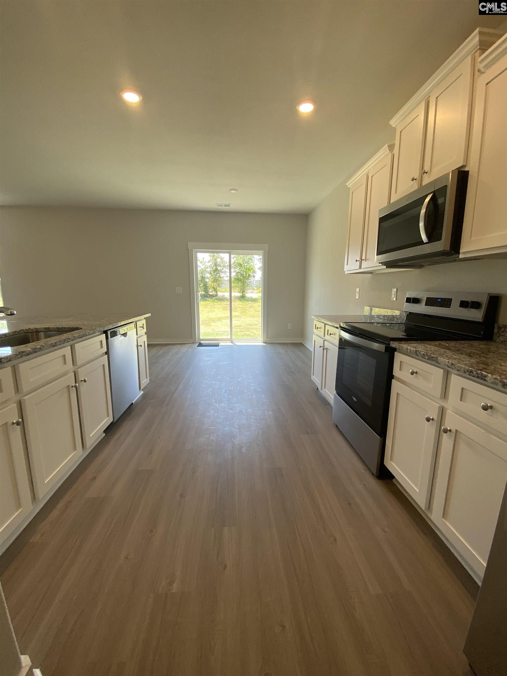 Located off the kitchen, the dining nook showcases luxury vinyl plank flooring and a large window.