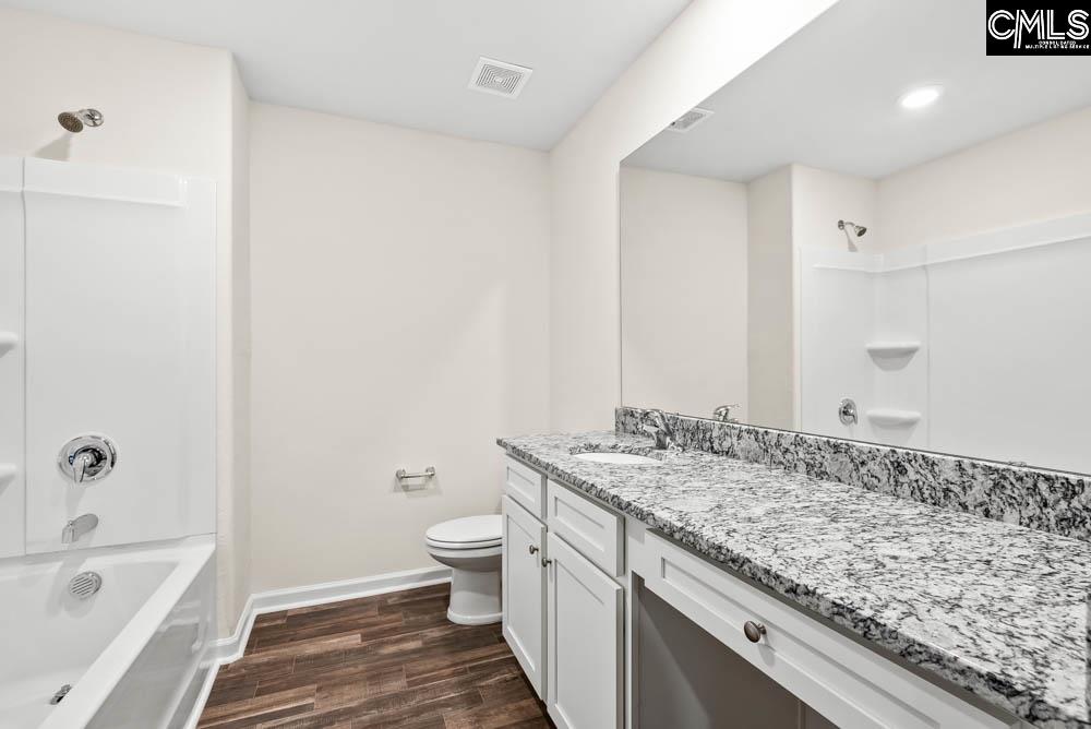 The second bathroom features a spacious vanity and tub/shower.