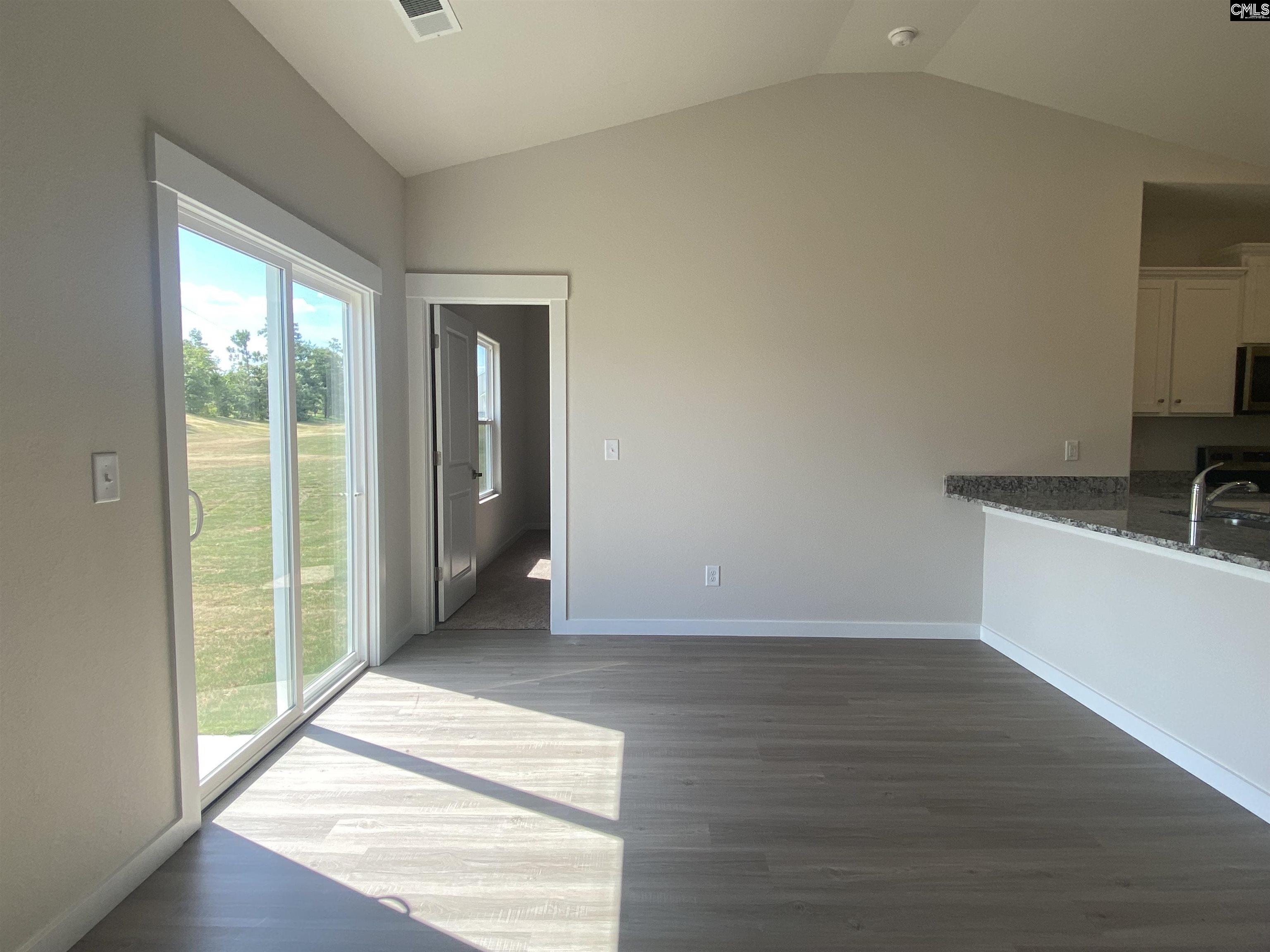 Located off the kitchen, the dining nook showcases luxury vinyl plank flooring and a large window.