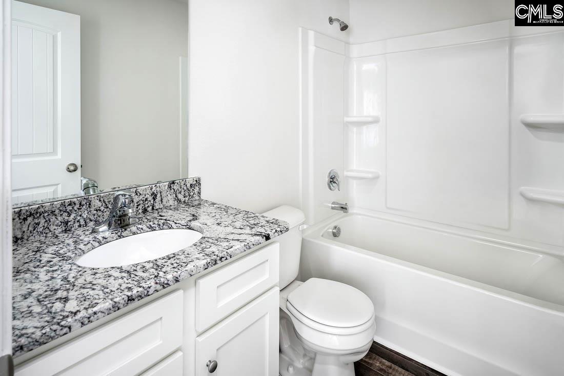The second bathroom features a spacious vanity and tub/shower.