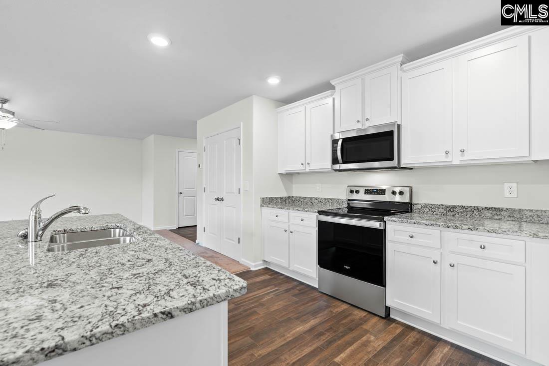 The kitchen features granite countertops and a full suite of stainless steel appliances.