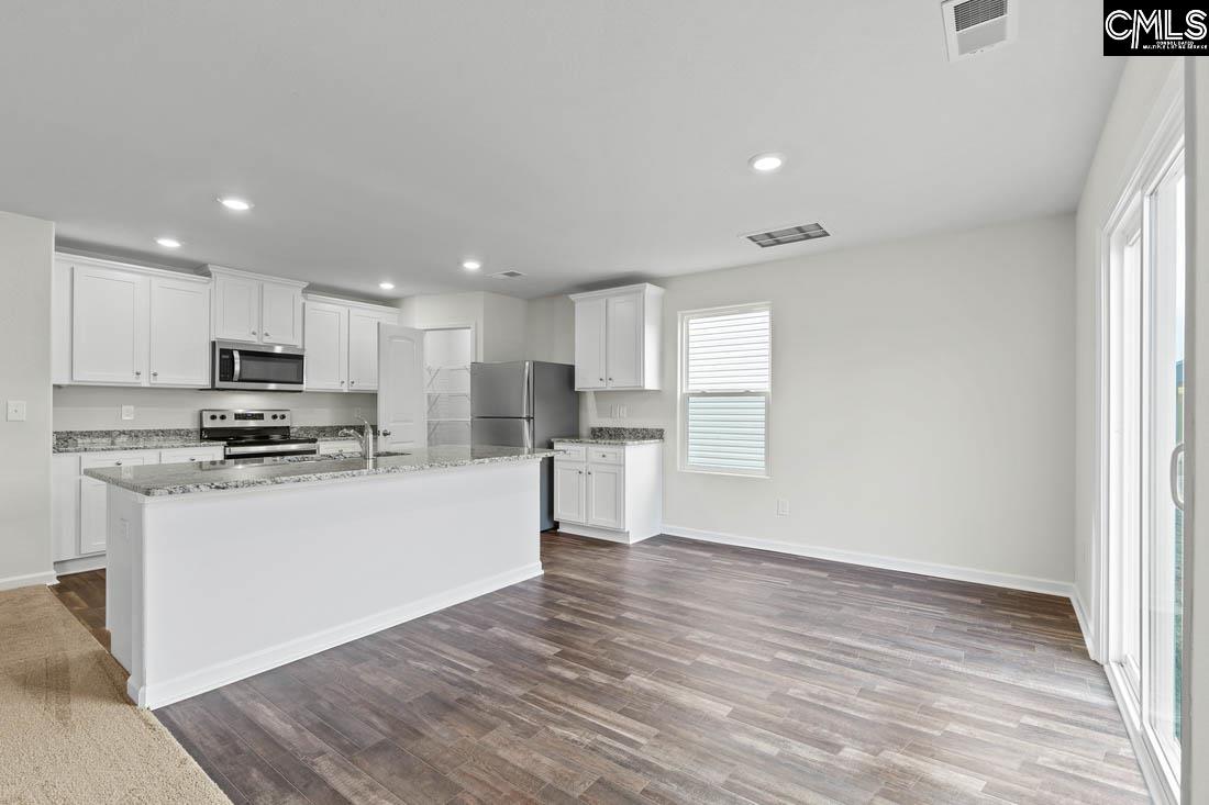 Located off the kitchen, the dining nook showcases luxury vinyl plank flooring and a large window.