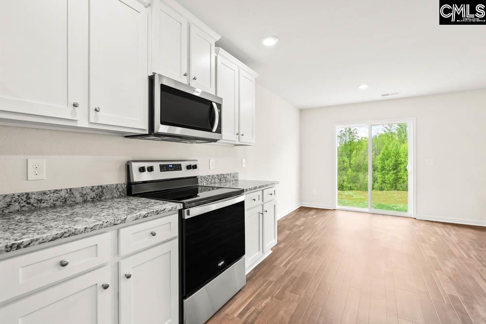 Located off the kitchen, the dining nook showcases luxury vinyl plank flooring and a large window.