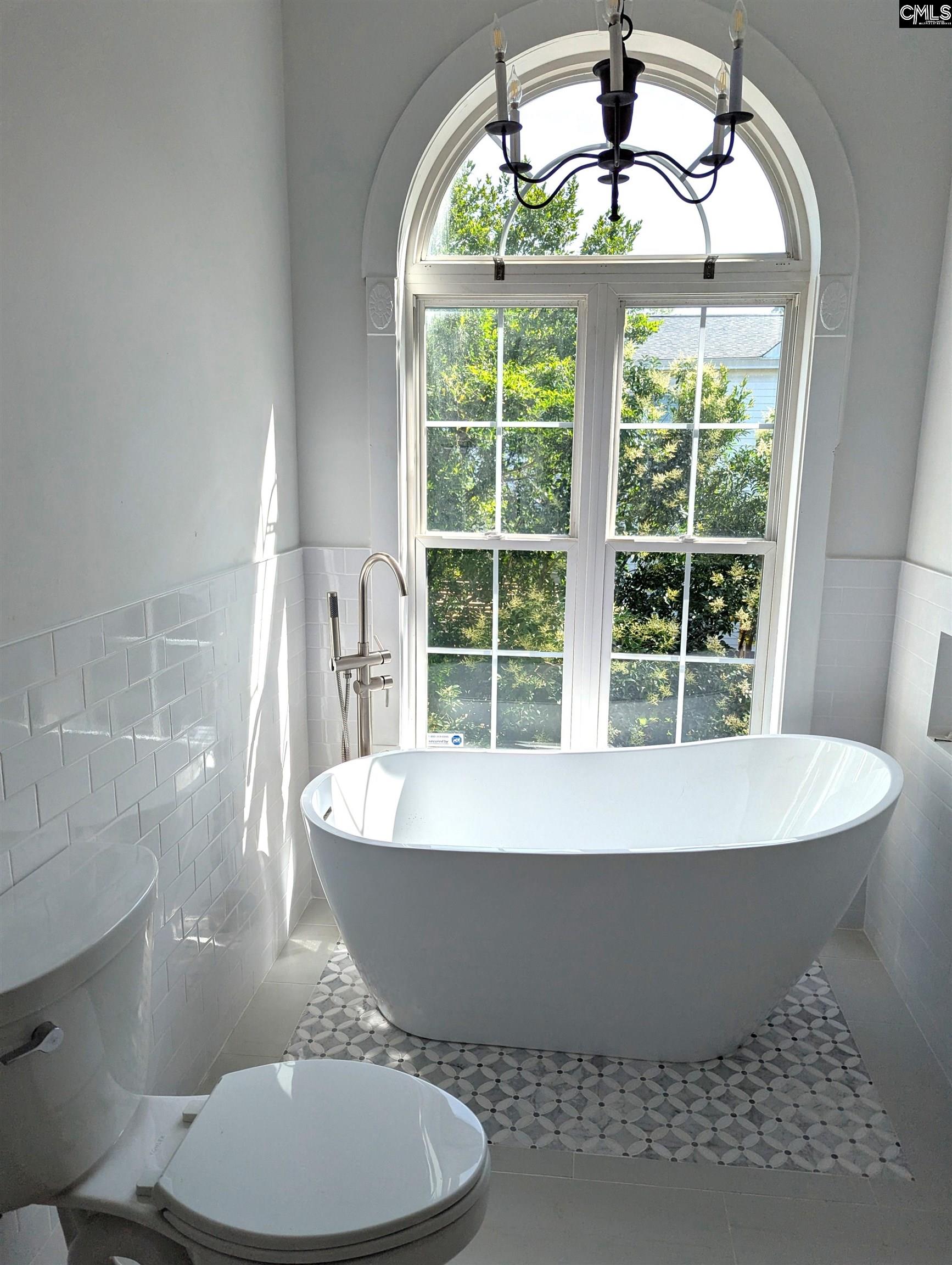 There is a new free standing tub, new toilet, new vanity, new flooring and new ceramic tile walls.
