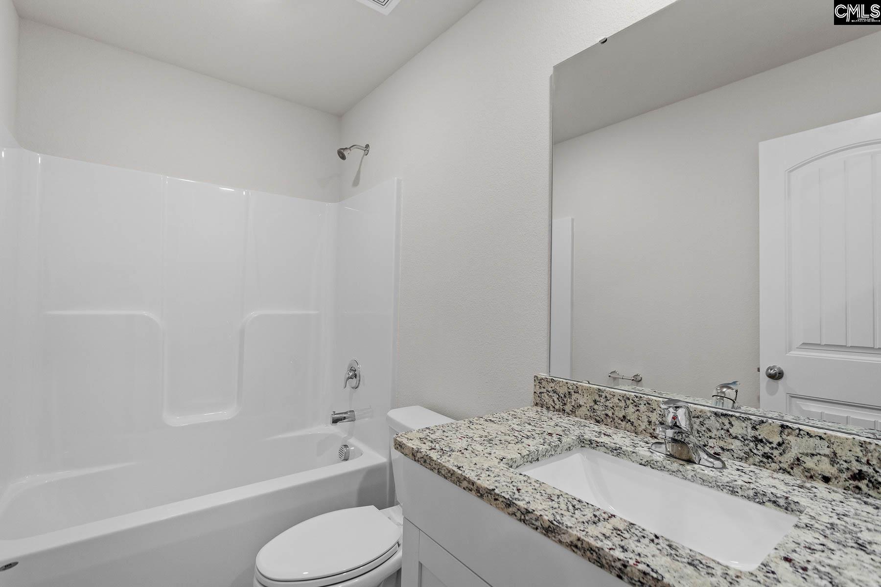 The second bathroom features a spacious vanity and tub/shower.
