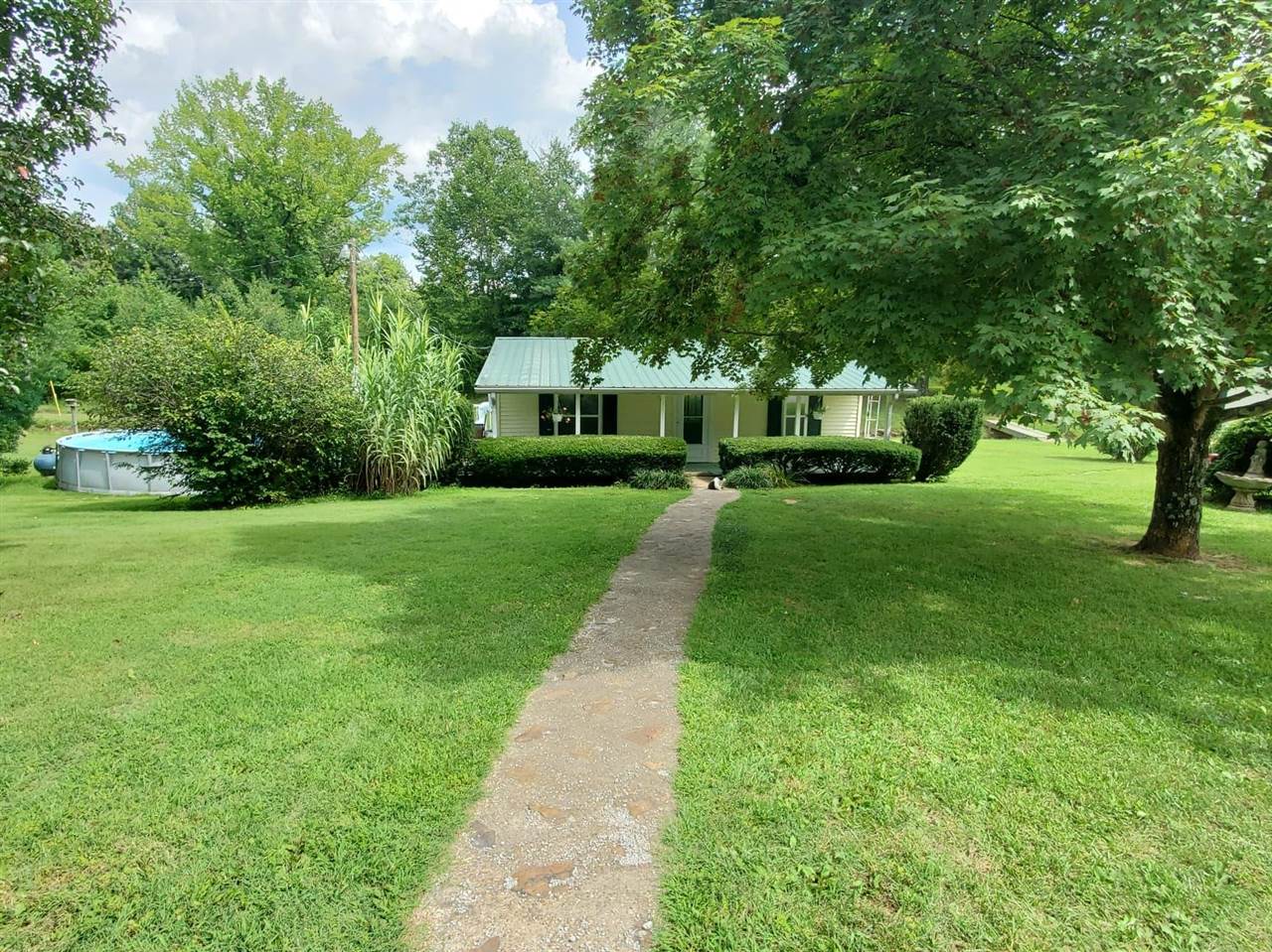 Great starter home or investment property! 2 Bedroom, 2 bathroom home resting on 1+/- acres with creek running through the property. Detached garage, outbuilding & pool included as well.