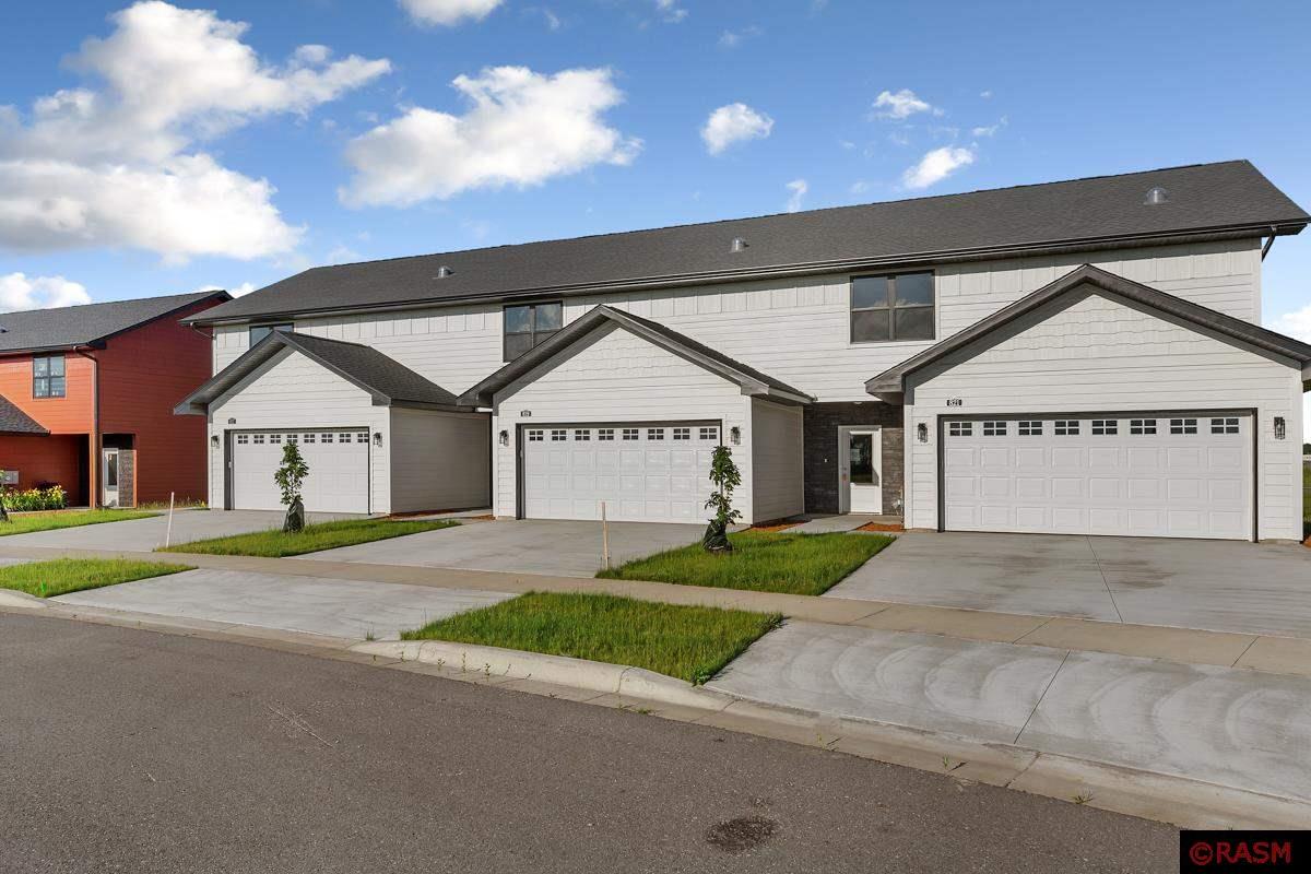 New construction on the outskirts of Belle Plaine, conveniently located less than 30 minutes from the Twin Cities just off Hwy 169. Prairie Garden Development is a new development customized for easy, upscale living. Custom builder and custom white cabinets are done by local cabinet maker. Three large bedrooms upstairs. Primary suite includes an extra large walk in closet and private bathroom. Additional bathroom upstairs. Lower level has an open floor plan, center island, patio doors and an abundance of natural light. Center unit with a beautiful view of the prairie and trail.  Must See!