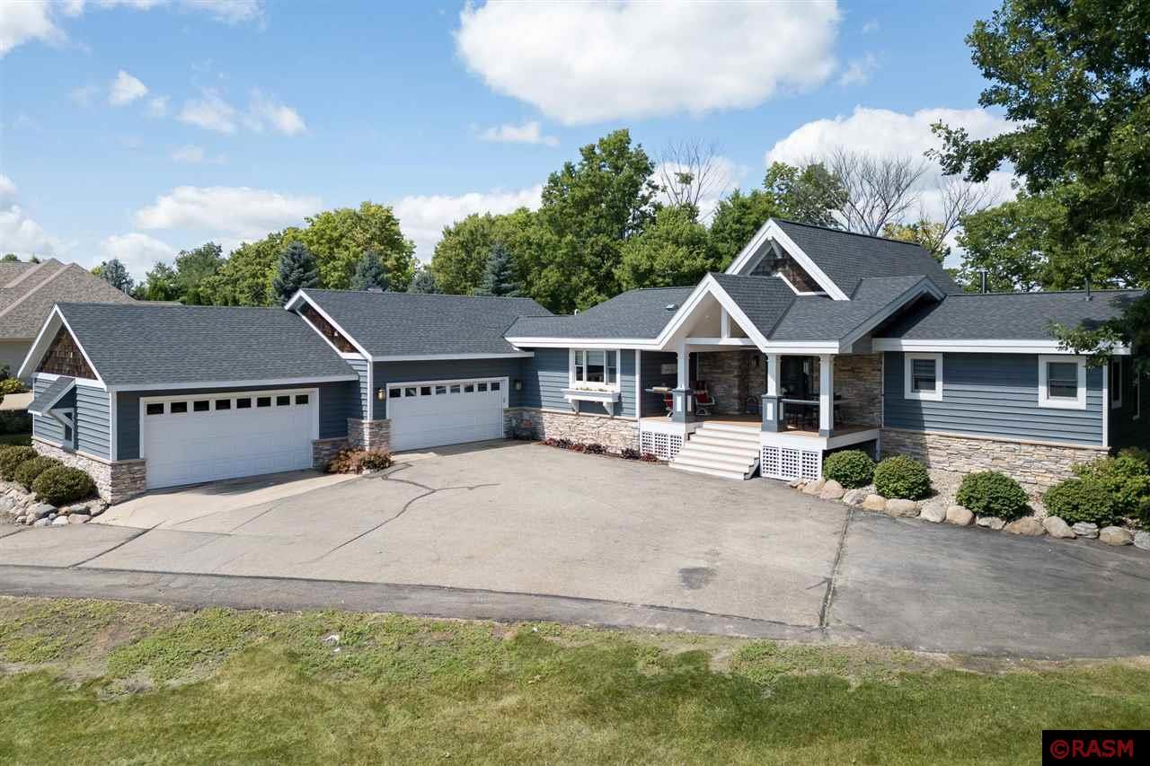 This timeless, well-maintained home on Madison Lake features 4 bedrooms, 3 bathrooms, and a spacious 4-stall garage. Situated on a generous 1.5-acre lot, the property boasts over 225 feet of stunning shoreland. Upon entering the home, you’re greeted by large windows that offer breathtaking views of the lake. The custom kitchen is equipped with luxurious Cambria countertops, and a high-end Sub-Zero refrigerator, making it perfect for cooking and entertaining. The main floor primary bedroom and the 3-season room look out to the lakeside and walk out onto a maintenance-free deck, perfect for enjoying the outdoors from both areas of the home. The upstairs balcony room is a versatile space, ideal for use as a bedroom, office, or any other need you may have. The walkout lower level features 2 bedrooms, a spacious family room, and a tiered media area perfect to watch tv on game days or movies with family or friends. The built-in Murphy bed in this area also adds extra sleeping for guests. Outside, you'll find a stone fireplace on the built-in patio, creating a cozy outdoor room perfect for enjoying lake living to the fullest. A convenient road in the back yard leads from the home to the lake, making it easy to transport items for a day of fun on the lake. Roof, furnace, air conditioner, water heater, and pressure tank - all less than 5 years old. Sellers dock, boat lifts, hurricane deck boat, and all patio furniture are included. This beautiful home on Madison Lake could be yours. With its stunning features and prime location, it offers a perfect blend of luxury and comfort for lakeside living.