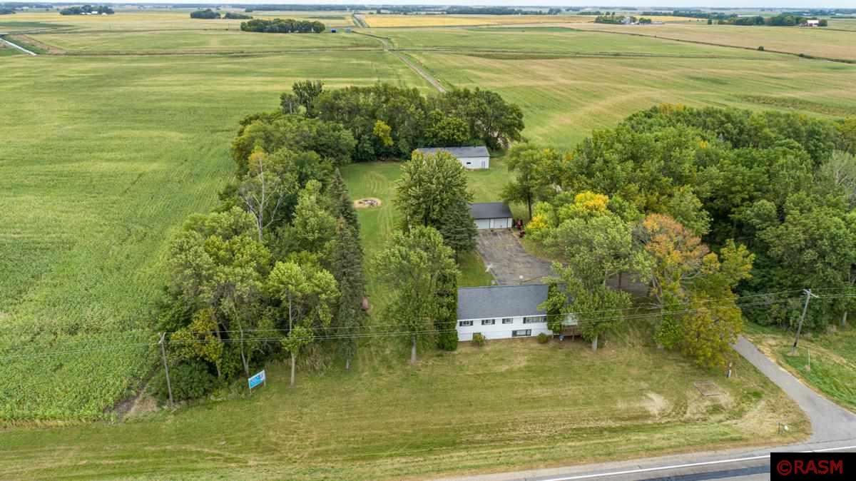 Embrace country living with this slice of peace and serenity. Sitting on approx. 2.3 acres, this property is very manageable! This property provides multiple outbuildings for all of your storage needs, consisting of a 32x68 machine shed, 30x40 3 stall garage and 24x28 oversized single stall garage! Additional exterior amenities include asphalt driveway from HWY 19 to the garages, upper level wrap around deck with a working elevator. Inside you will find this 5 bedroom has tons of potential! Upper level provides all necessary living amenities including 3 spacious bedrooms, 3/4 updated bathroom with a walk in shower, living room, kitchen, dining room, large laundry room with an additional 1/2 bathroom. Lower level family room with a wood burning fireplace! Other lower level amenities include a walk out basement with 2 additional bedrooms, living room, 3/4 bathroom and kitchen. Lower level could be used as a separate apartment if a buyer would choose. Lower level can use some TLC to suit your needs. Schedule your private showing today!
