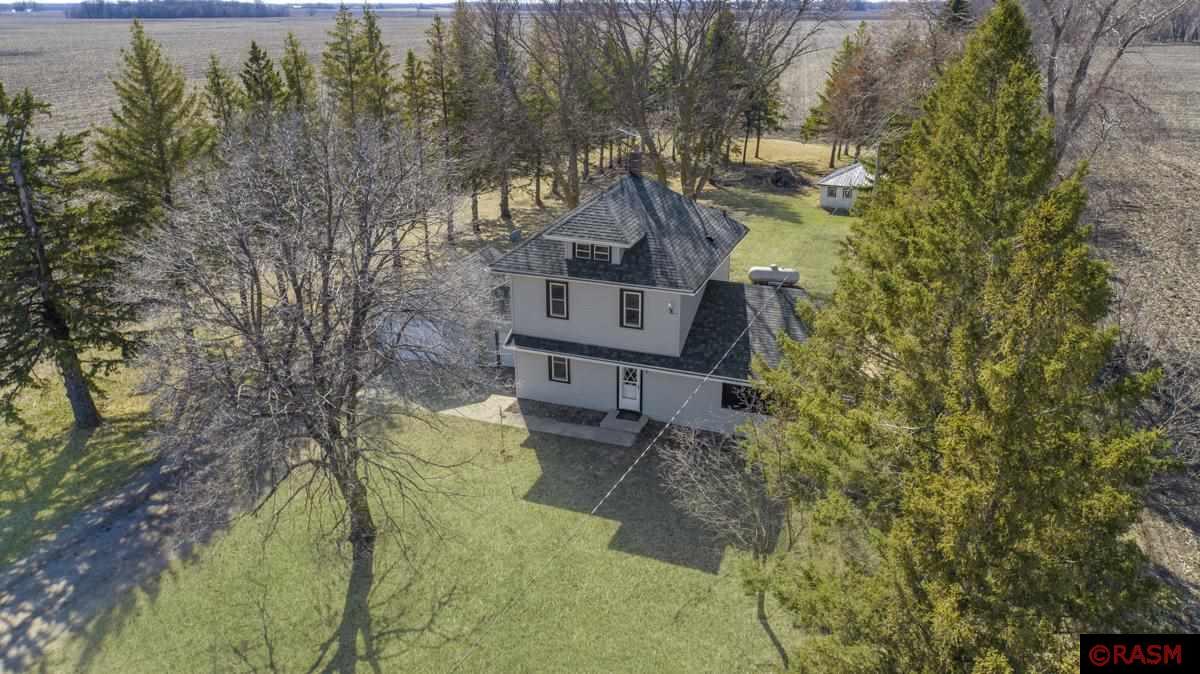 Just over an acre, but miles and miles of peaceful views of woods, fields and countryside, you'll find this modern farmhouse less than 30 miles from Mankato, and approximately 30 miles from southern metro. Stepping inside, you'll find an open Kitchen and Dining area. The Kitchen, aesthetically pleasing, with Granite countertops, Delta Faucet, Greige cabinets, Champagne gold hardware, white subway tile backsplash and warm chocolate toned plank flooring.  Also, the Kitchen is well functioning with a large pantry, plenty of storage, and a 2025 stove and microwave. The exclusive front living room is generous in size, and has wonderful light facing the East. The main level also homes a full bathroom and bedroom.  Upstairs you'll find the second bathroom with loads of storage, two additional bedrooms, one particularly with a large walk-in closet, and hallway storage. The lower level has two large rooms, one with washer/dryer and mechanicals. The second room, is very sizeable, and ready for a new owner's desire- it would make a great family room, game room, office or work-out area.  The green space breathes life and vibrancy with the mature trees, bushes and a lush, usable one-acre yard to enjoy evening bonfires, or summer gardens. In addition, this property has a detached storage shed, attached storage shed and a one car garage. The septic is compliant.