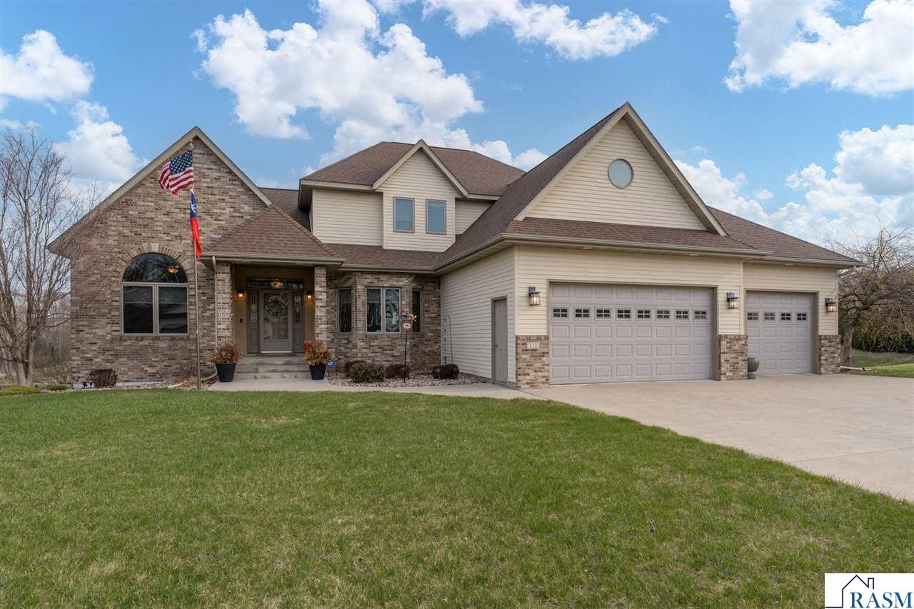 This property consists of two separate parcels being sold together. Extremely well maintained & move-in ready 2-story home located on Mankato's hilltop.  This home exudes quality & craftsmanship throughout, offers over 5,300 square feet, 5 bedrooms & 4.5 baths! The main floor is highlighted by the kitchen w/ Cambria countertops, stainless steel appliances, custom cabinetry & beautiful hardwood flooring, living room w/ vaulted ceiling & gas fireplace, formal dining room, office w/ French doors, sunroom, family room (added in 2016) w/ gas fireplace & sliding glass door for access to the maintenance free deck (also added in 2016). Finishing out the main floor is the laundry & 1/2 bath.  Moving upstairs, the primary suite offers a bath w/ whirlpool tub, separate shower & massive walk-in closet. Also located upstairs are three additional bedrooms and a full bath.  The walk-out basement features a spacious family room w/ gas fireplace, workout/recreation room (added in 2016), game room, 5th bedroom, full bath & the mechanical/storage room.  Additional features and recent updates to the home include: Insulated & finished 3-car garage w/EV charging; irrigation system; dual zone heating; custom blinds throughout; new roof installed (2023); new water heater installed (2022).  Please call today for your own private showing and see everything this immaculate home has to offer!
