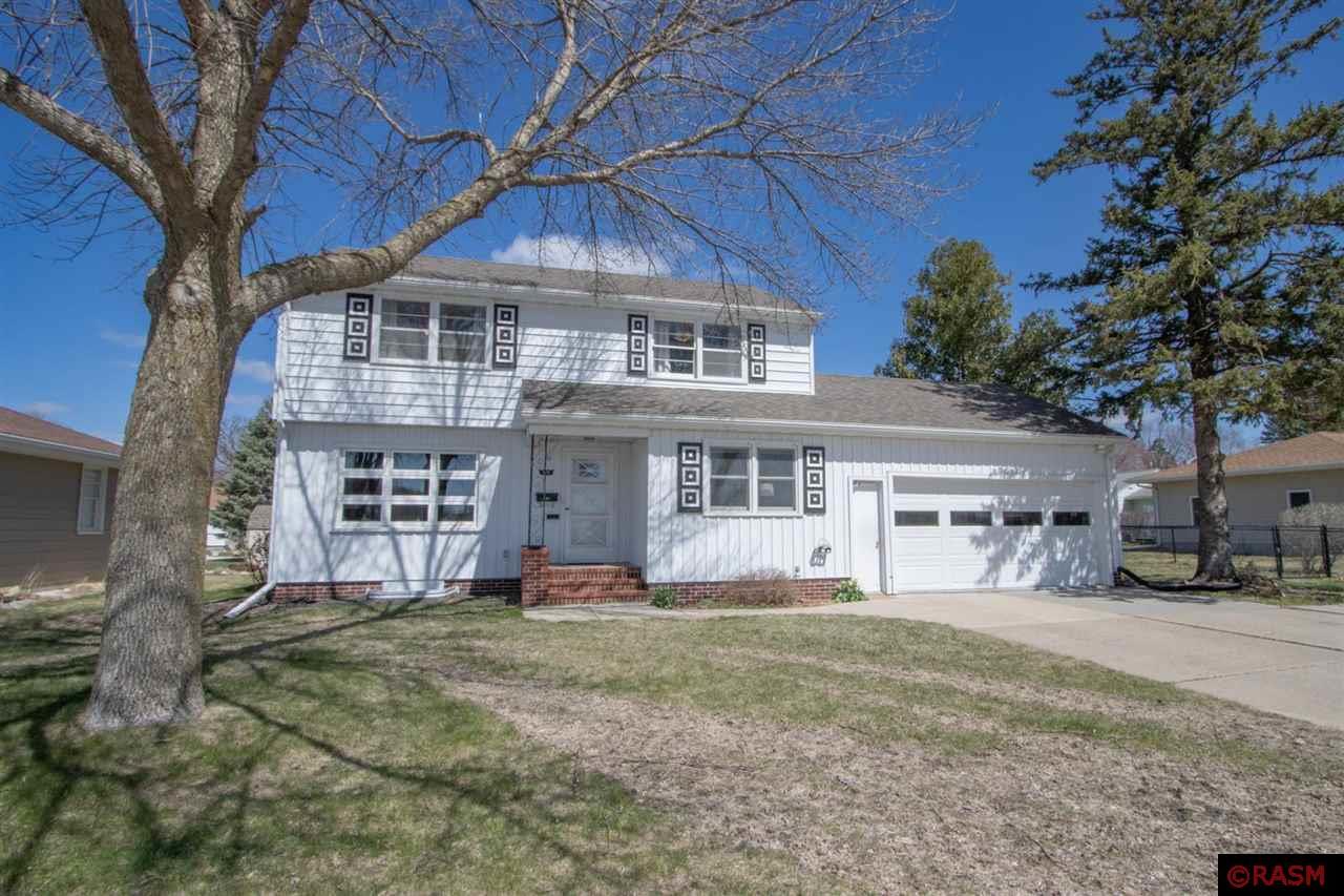 Welcome to this charming two-story home, conveniently located near Fairmont schools and shopping!  This property is a delightful blend of vintage flair and modern updates; with generous sized rooms, and a welcoming design.  The main level boasts a substantial living room with a built-in display unit; a grand sunken family room complete with a stone surround wood burning fireplace, beamed ceiling, built-in display shelving and hidden bar area.  In addition, the kitchen of this home is beyond spacious with loads of cabinets and counterspace!  There is even a pass-through access door in the kitchen that leads to the inside of the hidden bar in the family room… something that makes hosting gatherings a dream!  The main level is complete with a roomy bedroom, and adorable vintage half bathroom.  The stairs to the upper level are finished in hardwood and a beautiful banister greets and beckons you upward.  Once upstairs you will discover 3 magnificently large bedrooms, all with hardwood flooring.  The primary bedroom is large enough to host a king bed with sitting area, and has dual closet space!  There is a full bathroom on this level as well as an exit door that leads to an upper-level deck!  The basement level of the home offers an enormous bonus room complete with an egress window so it can serve as a rec room, family room or even a bedroom!  The laundry and utility room are spacious serve as the hub of the basement with access to the new ¾ bathroom and workshop/storage room.  Wait, did we say storage?  This house is chuck full of places to squirrel away your treasures!  Even a cedar lined closet in the upper-level hallway!  The backyard is a dream!  It’s enormously spacious, sprinkled with beautiful perennials and complimented with a patio space AND a deck.  Let’s not overlook the storage shed, the completely fenced in backyard and the wonderful double attached garage as well.  This is a gem and you are not going to want to miss this it! *Listing agent related to seller*