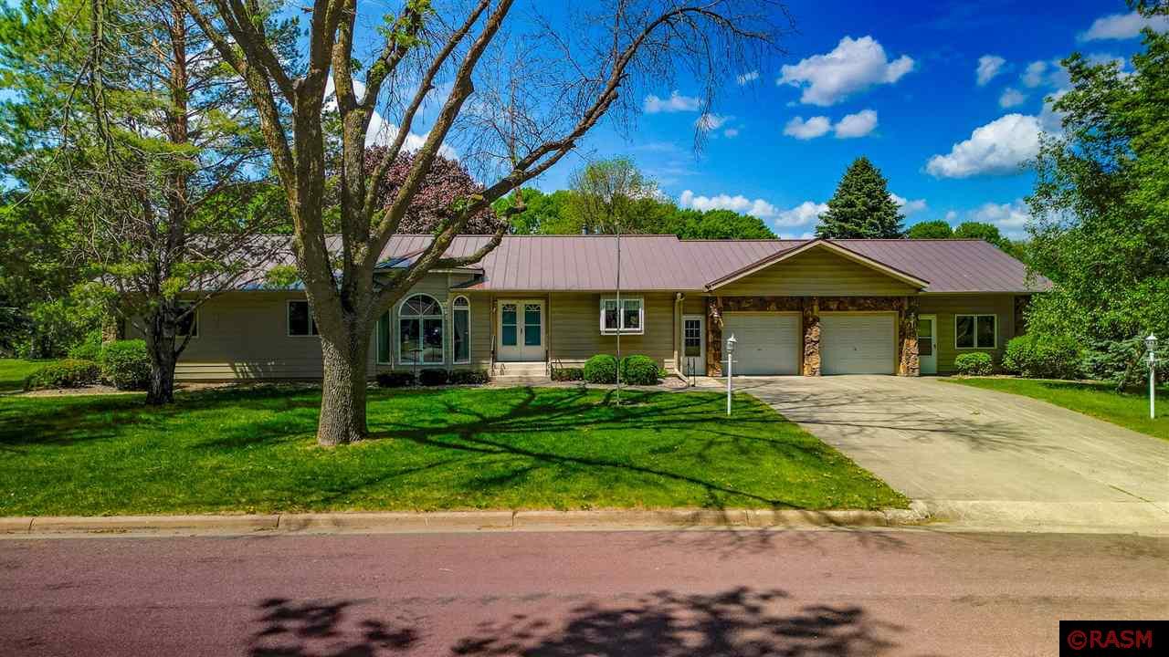 Truly unique, custom-built property must be seen to appreciate all the character this home offers. Full of mid-century modern touches throughout, the grand double-door entry opens to a sunken formal living room with serene views of the landscaped yard. A casual seating area that leads to the aggregate patio and fenced yard sits beyond the living room. A formal dining space with gas fireplace and exotic chandelier, kitchen with updated countertops and appliances, 1/2 bath and laundry room with additional stove, sink and pantry space, complete the main living spaces. The other wing of the house features a primary bedroom with en suite bath and walk-in closet, 2 bedrooms and full bath. The full basement is 2300 square feet with a blank slate! A separate staircase leads to the backyard, there is a wood stove, 1/2 bath, and PLENTY of space. Outside, the large corner lot is nicely landscaped, with a privacy fence around the patio, and lovely plants. The garage is sure to delight as well; a large double garage opens via double doors to a 3rd stall that is suitable for a workshop, storage, or garden shed area (has a separate service door to the backyard) + it's set up for heat and even more storage. Updates include a steel roof, newer furnace, and general maintenance of well-care. Don't miss this hard-to-find property!