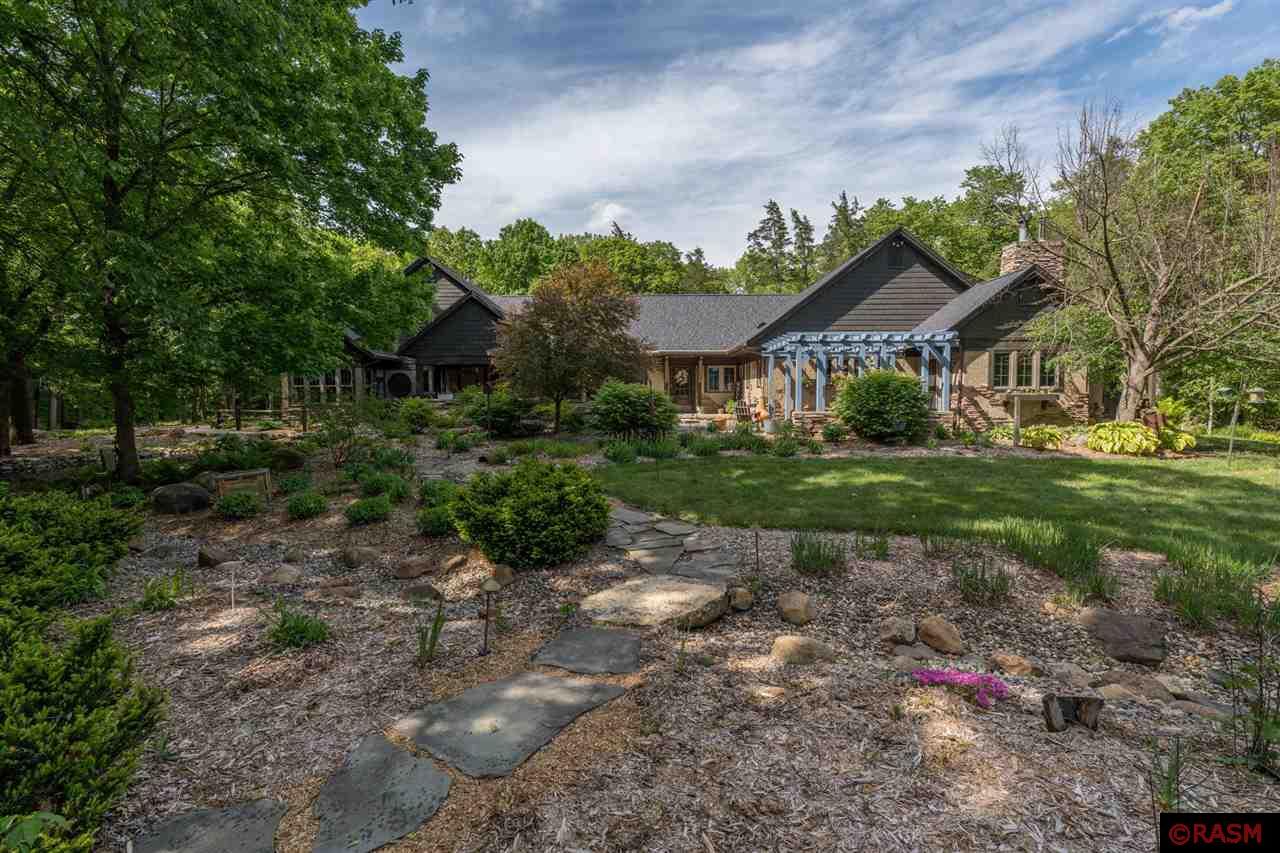 Welcome to "The River" – A Sanctuary of Connection, Comfort, and Adventure Tucked away on 17.4 lush acres along the winding Maple River, this isn’t just a home—it’s a destination, a retreat, and a gathering place for all seasons of life. Here, beneath the whispering trees and along the river’s edge, every moment feels like a memory in the making. From the moment you arrive, The River wraps you in warmth and possibility. The heart of the home is its expansive chef’s kitchen—designed not just for cooking, but for creating. Imagine shaping dough for handmade pizza, laughter echoing through the open space as pies slide into the custom pizza oven. The kitchen flows effortlessly into a generous family room, where windows frame views of the Maple River and woods beyond. This space invites you to relax, unwind, and connect. With four spacious bedrooms and four baths, comfort and privacy are yours to enjoy. Whether you’re hosting holiday gatherings, weekend retreats, or quiet evenings, this home is designed for effortless living and entertaining. Two screened porches invite you to savor life outside—whether you're sipping coffee at sunrise, watching fireflies dance at dusk, or sharing stories late into the night with nothing but the sounds of the river and the rustle of the trees around you. Step outside and adventure calls. Kayak along the Maple River as wildlife surrounds you. Cast a line, hike through your private woods, or simply listen to the current as it carries time downstream. In winter, the landscape transforms into a serene wonderland. Every inch of this property invites exploration and reflection. The River isn’t just where you live—it’s where life unfolds. A place for meaningful connection, inspired gatherings, and tranquil escapes. It’s a home that invites you to slow down, dig in, and stay awhile. Welcome home. Let the story begin.