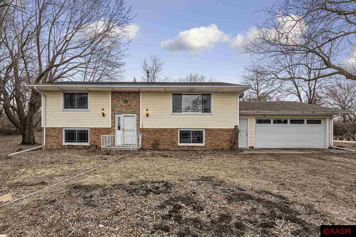 Located just minutes from Mankato off of HWY 68 in a rural subdivision, this home is situated on nearly an acre of land.  Step up to the inviting main floor that offers 2 spacious bedrooms, full bath, large living room and generous sized kitchen that opens directly to the deck facing the semi-private backyard. In the lower level you will find 2 additional bedrooms, 3/4 bath, large family room and a utility/laundry room with direct access to the 2 stall heated garage.  Brand new septic system and storage shed.  This home is located in the LCWM school district but open enrollment in Mankato is an option.