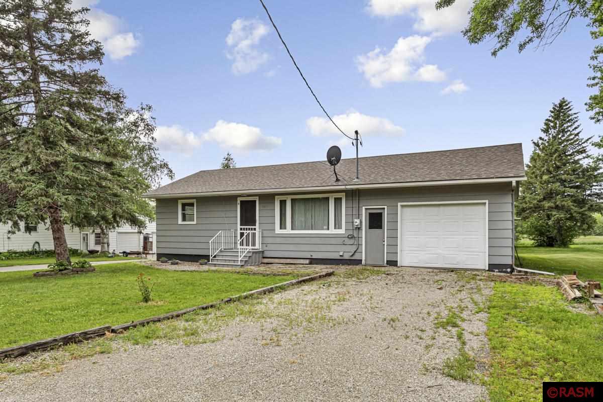 Welcome to this delightful 2-bedroom Rambler, with THREE car garage south of Mankato in the quaint town of Minnesota Lake. The unfinished basement has room to grow for future expansion if needed, with an existing toilet and shower.  This sweet home is just steps away from the beautiful lake and park. The spacious and welcoming living room has rustic barnwood flooring, built-in shelves and a welcoming front entrance. The very functional Kitchen has sturdy oak cabinets, caramel toned countertops and tile floors. 2 bedrooms on main, and full bath with tiled shower.  Relax around your own firepit in the peaceful and private back yard. Attached single garage, PLUS 20 x 20 detached garage. Enjoy your new home!