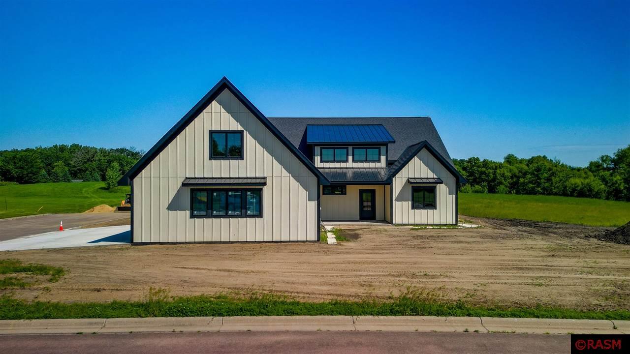 Stunning new construction patio home located in the sought after Crystal Creek Subdivision. Experience the perfect blend of modern elegance and cozy comfort in this beautifully designed 3-bedroom, 3-bath patio home. The open floor plan features a bright and airy living space with a striking gas fireplace accented by a shiplap wall, custom soft-close cabinetry, a statement kitchen island, stainless steel appliances, and a walk-in pantry with a swinging butlers door. Enjoy seamless indoor-outdoor living with a walkout to the covered patio, ideal for relaxing or entertaining. The main-floor primary suite offers a luxurious walk-in tile shower, separate soaking tub, and a spacious walk-in closet with direct access to the laundry room for ultimate convenience. There will be a wrought iron railing on the open staircase that leads to a versatile upper-level bonus room with a full bath—perfect for guests, an office, or media space. Additional highlights include black window casings, transom windows, metal awnings, and an oversized 3-stall insulated and sheetrocked garage. This home also features an on-demand water heater and quality finishes throughout.