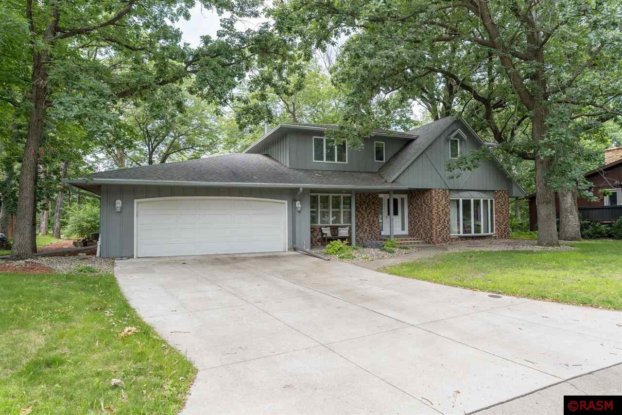 Nestled at the end of a quiet cul-de-sac, this beautiful home offers sweeping ravine views and a versatile layout designed for comfort and function. From the moment you arrive, you’ll be charmed by the paver sidewalk and cozy sitting area that welcome you to the front entry. Step inside to a bright and spacious main floor where large windows frame peaceful backyard views, and stunning hardwood floors run throughout the open concept living and dining spaces. The kitchen is thoughtfully designed with abundant cabinetry, a built-in wall oven, cooktop, and generous workspace. It flows seamlessly into the dining and great room areas, anchored by a gas fireplace and patio doors that lead to an expansive back porch, deck, and lower patio. Also on the main level: a convenient bedroom or home office, a laundry room with sink, and a nearby ¾ bath. Upstairs, the spacious primary suite includes a private ¾ bath, and three additional bedrooms offer plenty of room for family, guests, or hobbies. One of these bedrooms features a walk-in closet. The walkout lower level expands your living space with a family room, a sixth bedroom, a ¾ bath, and a large mechanical/storage area. Don’t miss the large workshop/storage room with exterior access—ideal for projects, tools, or seasonal items. Step outside and be immersed in the serene surroundings—whether you're enjoying a quiet morning on the patio or a sunset on the deck, you’ll often spot deer, wild turkeys, songbirds, and more. The backyard is truly a retreat for nature lovers, offering a front-row seat to the area’s abundant wildlife. One of the deck’s unique features is its engineered section, designed to support a hot tub—adding yet another layer of potential for outdoor enjoyment. The attached garage is finished with an epoxy floor and is prepped with electric and gas hookups for a future heater. In the winter, the views are stunning, while in the summer, the setting offers exceptional serenity. Don’t miss your chance to own this remarkable property—schedule your private tour today!