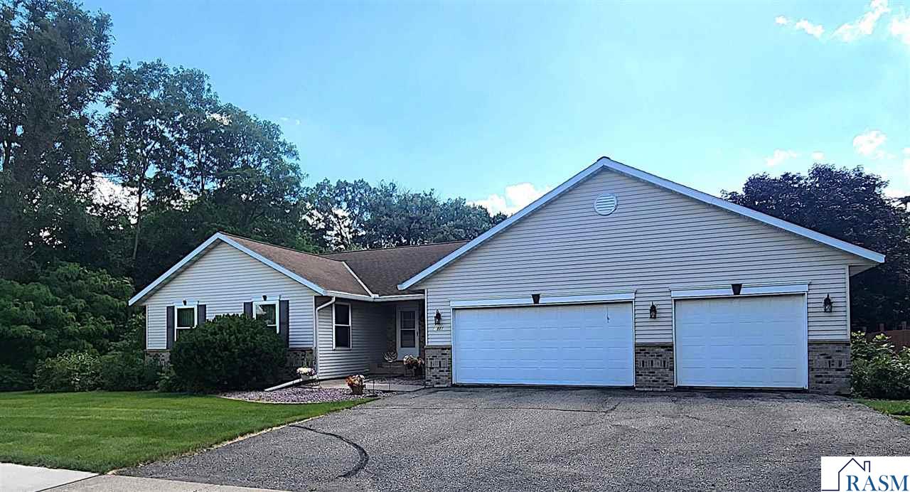 Discover this beautiful rambler tucked away on a tranquil ravine lot, perfectly situated in an established neighborhood of upper North Mankato. The privacy provided by the mature trees enhances the serene outdoor experience. Upon entering, you’re greeted by a large living room with breathtaking views of the landscaped surroundings that also extend to the adjacent formal dining room. The eat-in kitchen features modern updates, including new appliances, a new sink and faucet, and plenty of cabinet space. The original garbage compactor is a charming nod to the home’s history. Step out onto the composite/vinyl deck to enjoy a BBQ or simply relax while taking in the scenery. A convenient mudroom adjoining the kitchen houses a laundry area with a wash tub and provides direct access to the garage. Rounding out the main level are two bedrooms, den/office, and two bathrooms. The lower level is perfect for gatherings, complete with a welcoming family room featuring a gas fireplace and access to the walk-out patio. Two additional bedrooms, a craft room (perfect for your hobbies or an additional workspace), ¾ bathroom, and a generous storage room round out this level. Enjoy peace of mind with recent updates, such as the new water heater and water softener (both installed in 2021), and a well-maintained furnace from 2012. The property is equipped with an in-ground sprinkler system, some newer windows, attached 3-stall garage, and practical gutter helmets. This inviting home is ready for you to make lasting memories - schedule your private tour today!